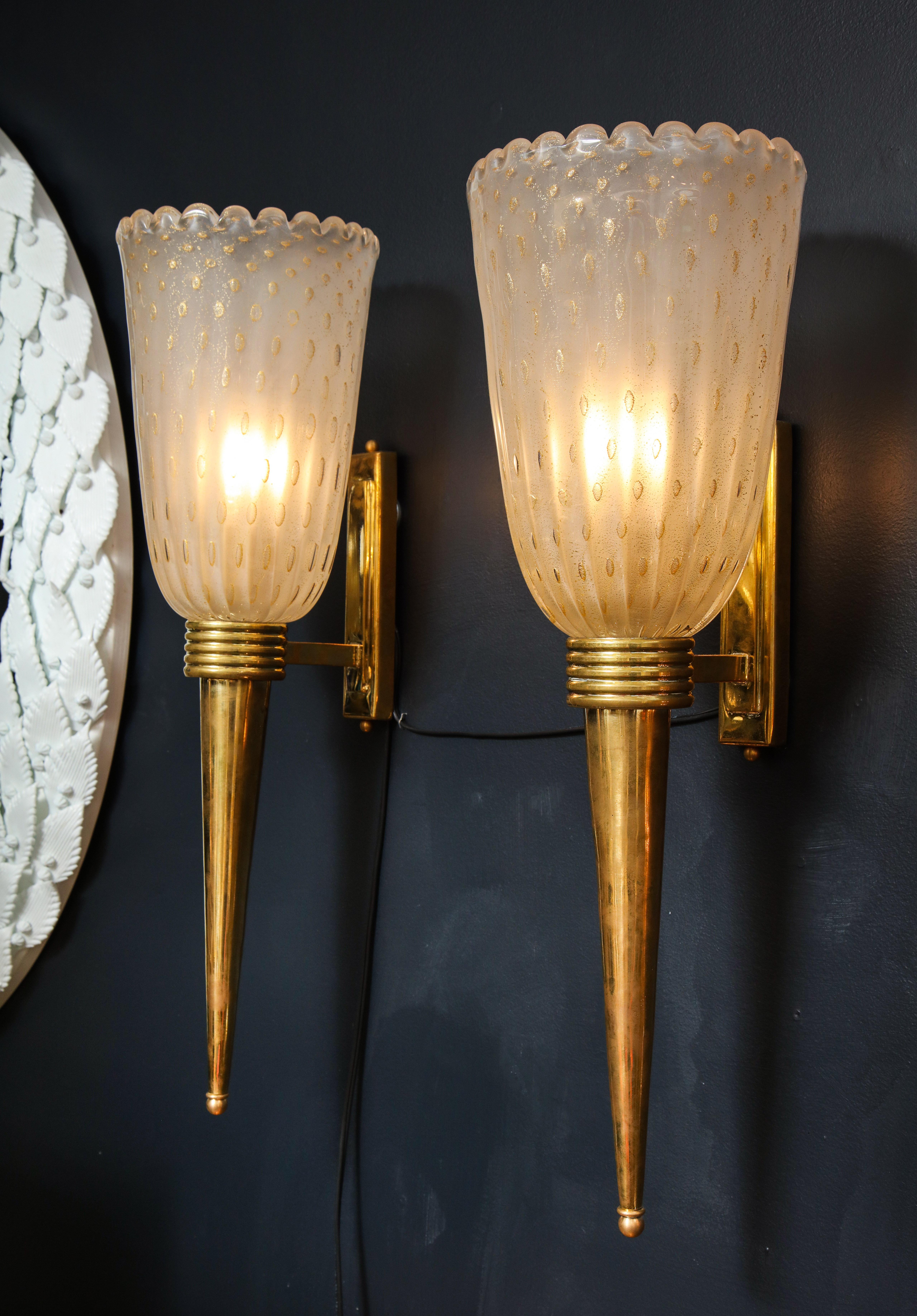 Handblown pair of torch-like sconces consisting of a ivory infused with 24-karat gold flecks. 