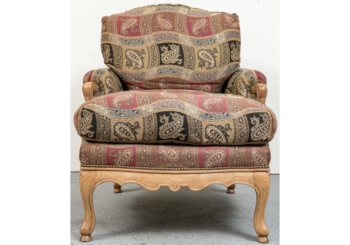 Pair of J. Robert Scott lounge chairs with loose pillow back and seat, natural wood frame with scalloped apron accentuated with brass railheads. The chairs with short upholstered and wood arms and resting on cabriole legs. Comes with one matching