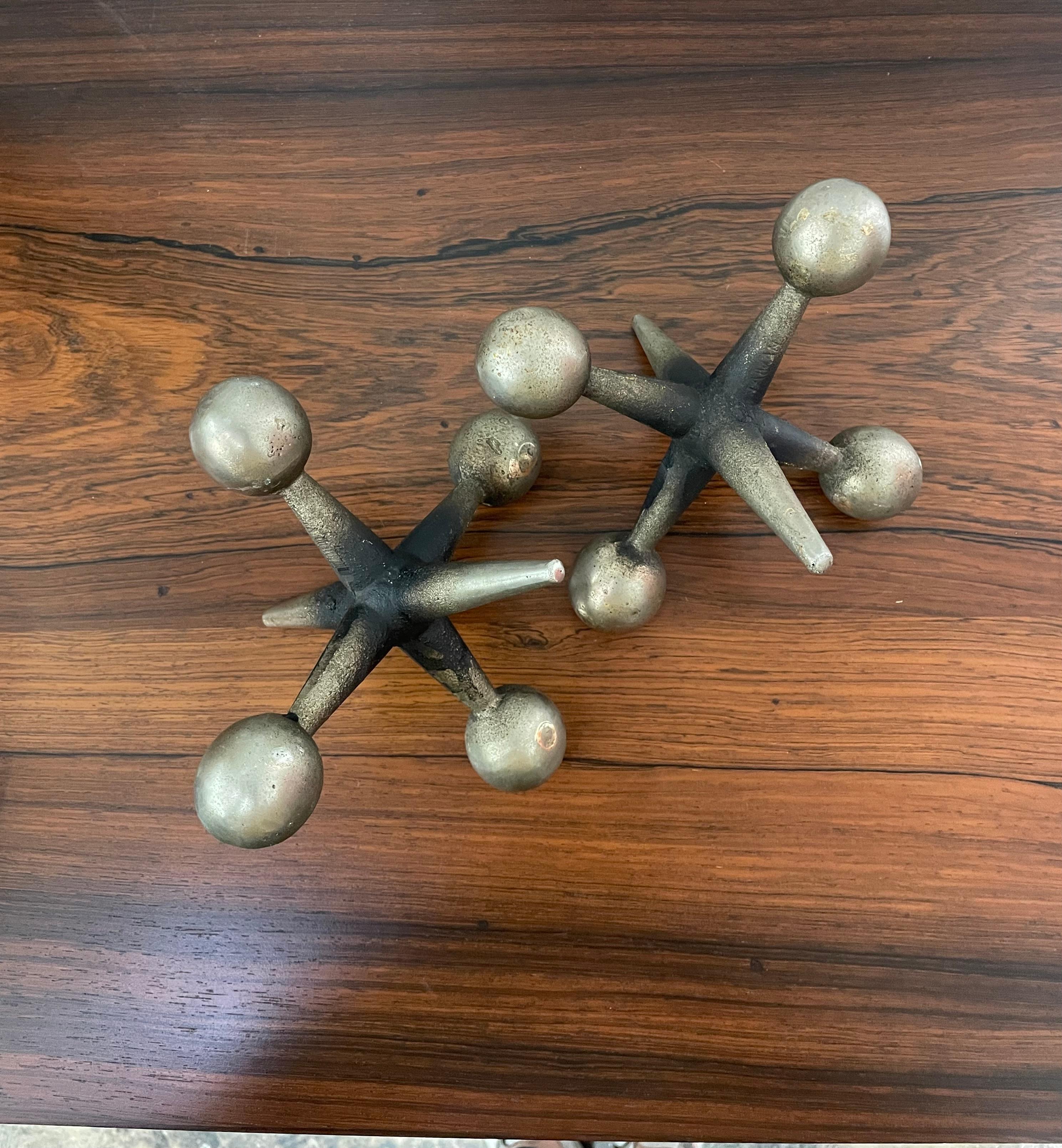 Mid-Century Modern decorative jack bookends by Bill Curry. Made of heavy cast iron.

Great bookend, paperweight or iconic Mid-Century Modern decor made of iron. Amazing condition for its age. Some natural occuring wear and patina that adds to its