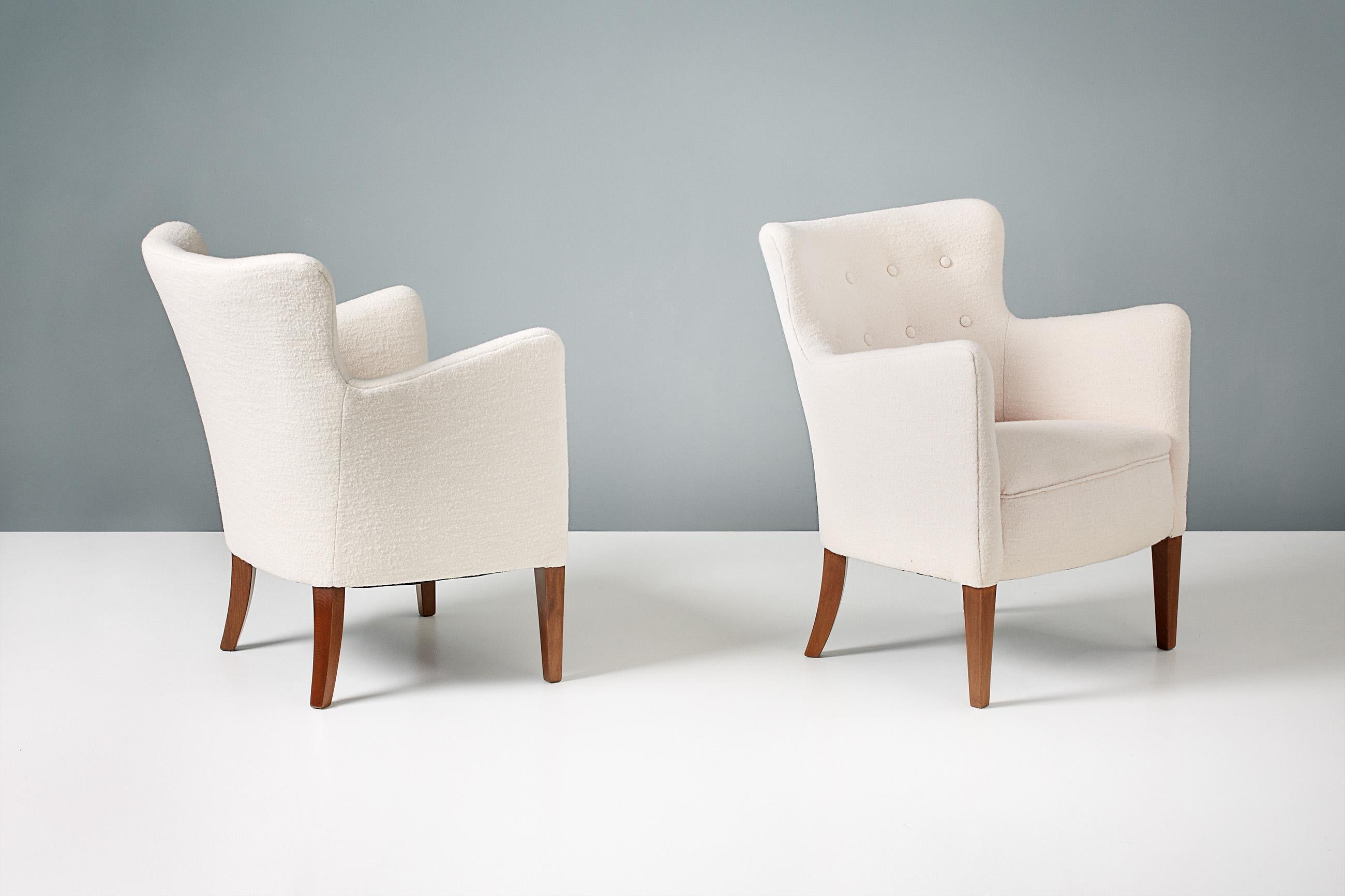 A pair of 1940s lounge chairs designed and made by master-cabinetmaker Jacob Kjaer. These examples have been reupholstered in off-white pure wool fabric from Chase Erwin in England. The legs are solid mahogany.

Each chair has been fully
