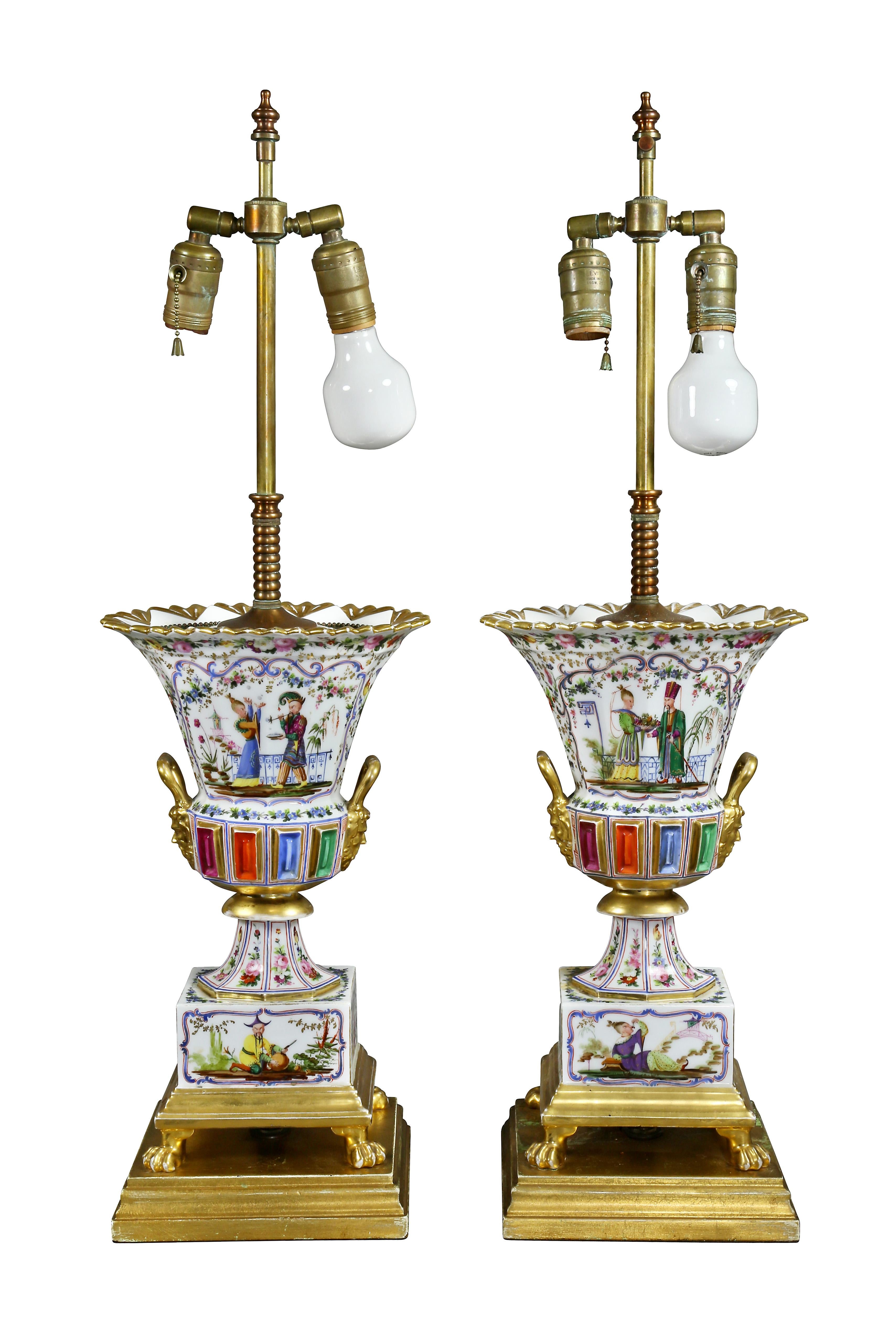 Each with figures and floral decoration with jeweled midsection with gilt masks, square base with paw feet.