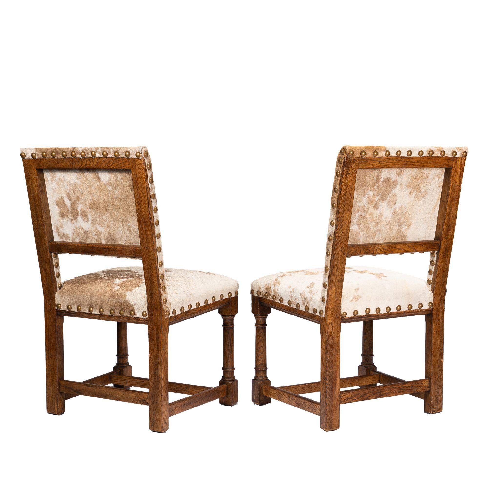 Pair of Jacobean style hair on hide oak side chairs, 1920-35 In Excellent Condition For Sale In Kenilworth, IL