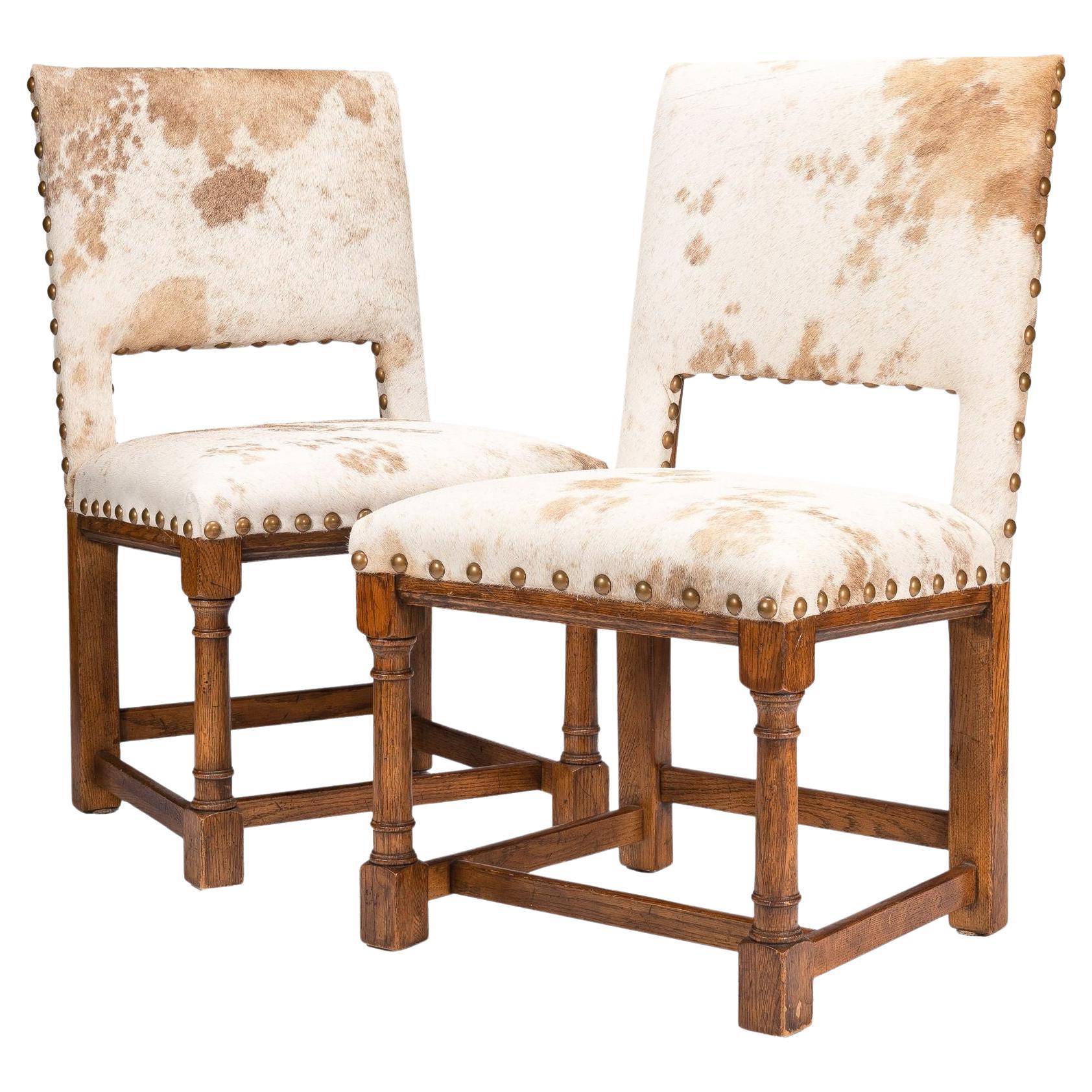 Pair of Jacobean style hair on hide oak side chairs, 1920-35 For Sale