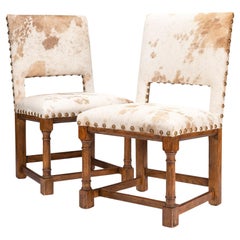 Pair of Jacobean style hair on hide oak side chairs, 1920-35