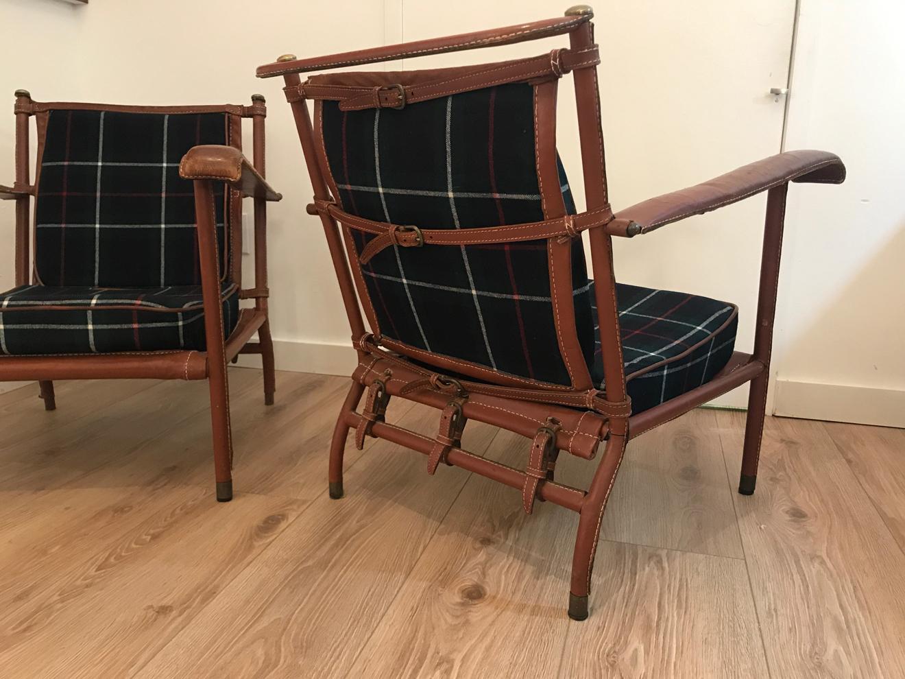 Rare pair of Jacques Adnet lounge chairs with new tartan plaid wool upholstery. Original brown hand-stitched leather in good vintage condition.
Priced per pair. Four lounge chairs available.
FREE SHIPPING: White Glove to Continental US.