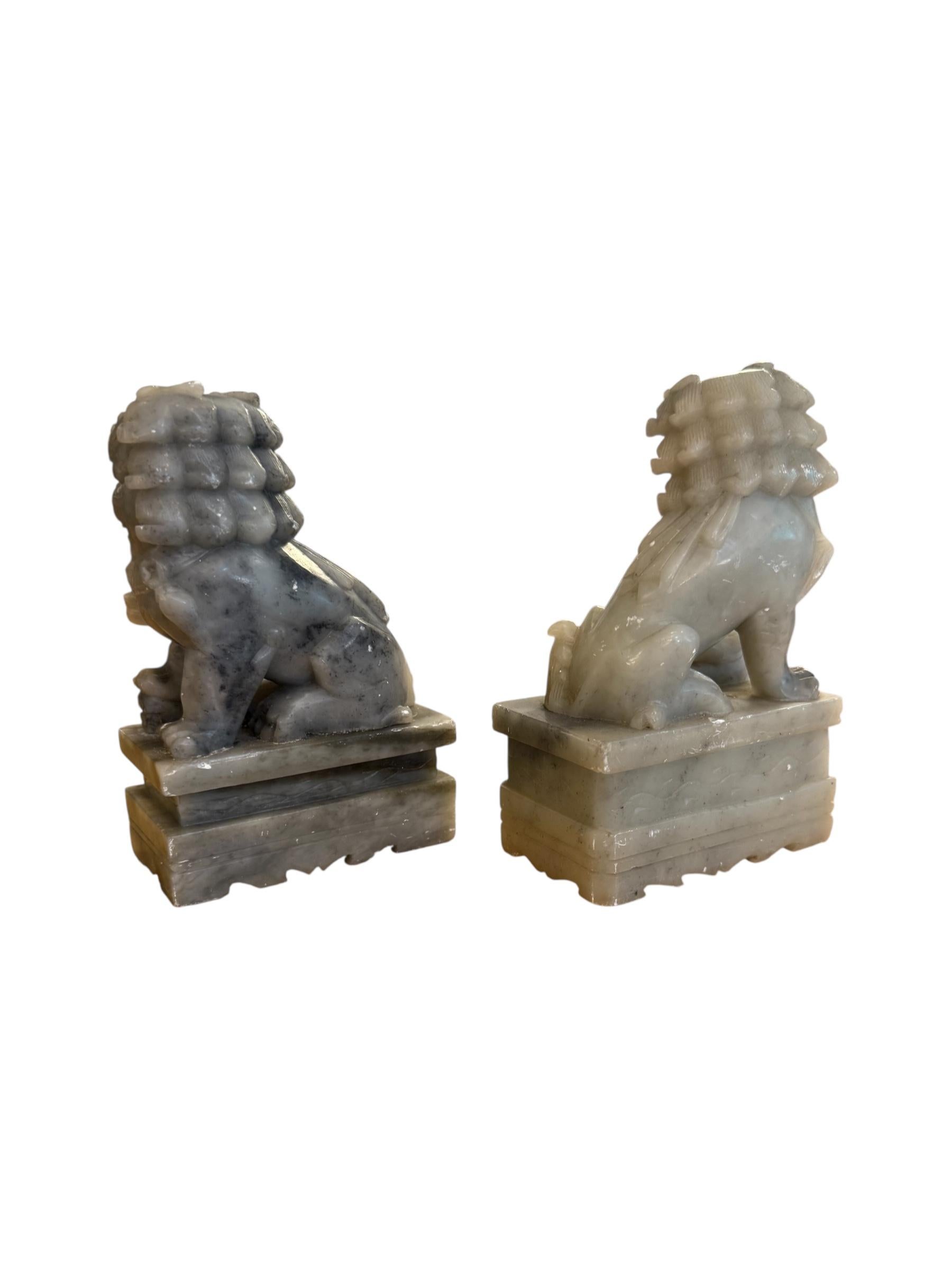 Guard your literary treasures with this exquisite pair of hand-carved jade Foo Dog bookends. Symbolizing strength, protection, and prosperity, these mythical lion-like guardians are meticulously sculpted with intricate details—from their fierce
