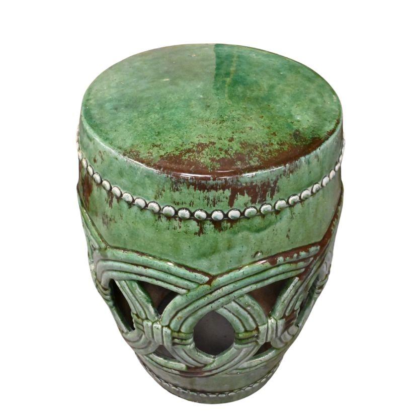 A pair of ceramic glazed garden stools in a dazzling shade jade green.  Each stool is kiln fired with a process used for hundreds of years and the glazed finish is unique to each piece.  The stools have an overlapping open circle design and beaded
