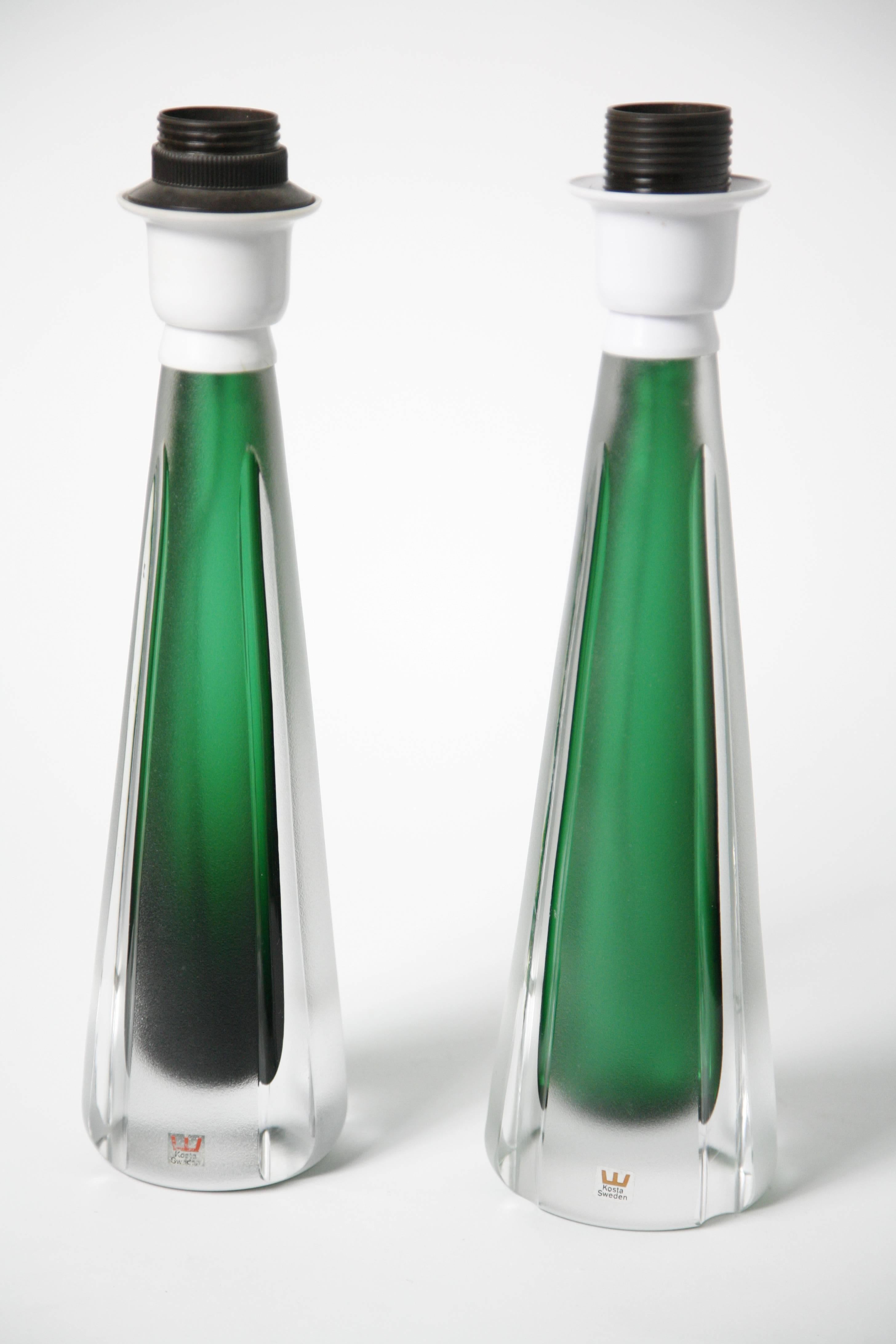 Pair of Jade green and clear glass lamps by Kosta, Sweden, 1980.
Partly frosted green glass and clear smooth clear glass, these are extremely beautiful the base is very heavy as it is all glass just the inner core is hollow, they are signed Kosta