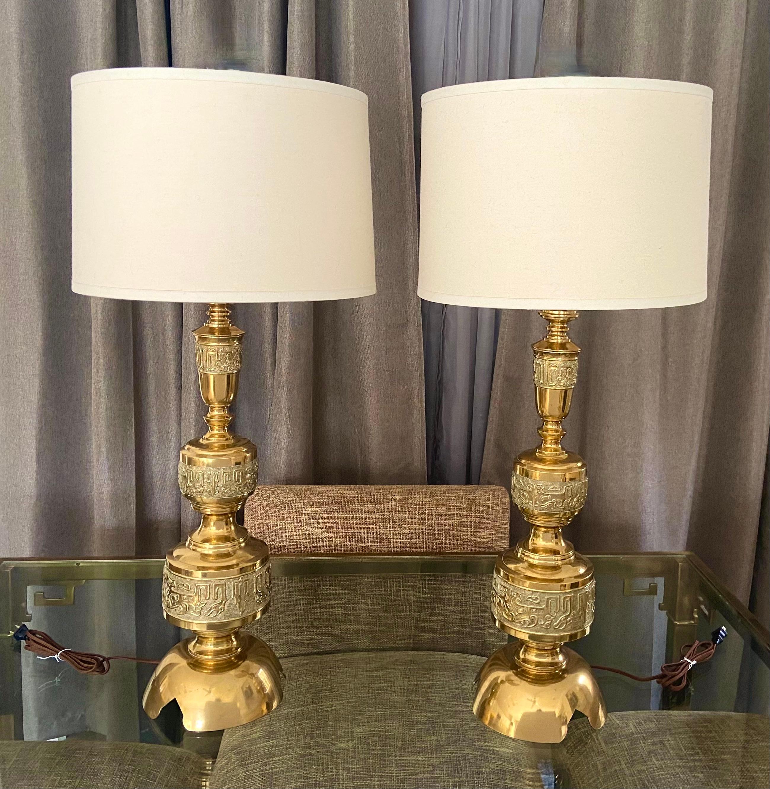 Pair of large Asian inspired brass or bronze table lamps in manner of James Mont. Newly wired for US with new three-way brass sockets and cords. Shades are not included and are shown for photography purposes only.

