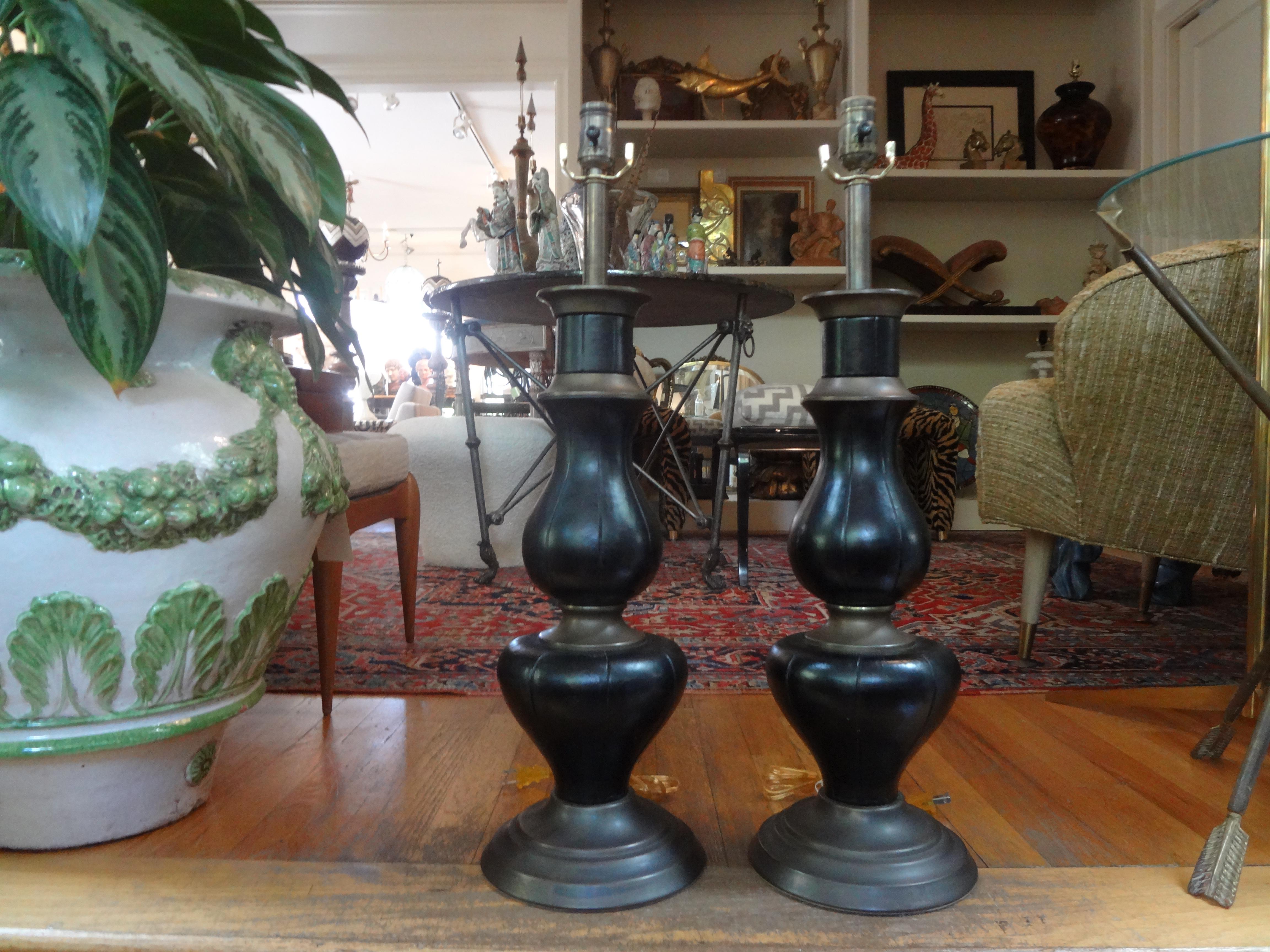 Pair of French Jacques Adnet inspired brass and leather lamps.
Fantastic pair of vintage sculptural brass and leather table lamps with brass bases. These handsome substantial lamps have been newly wired with new sockets and would work well in a