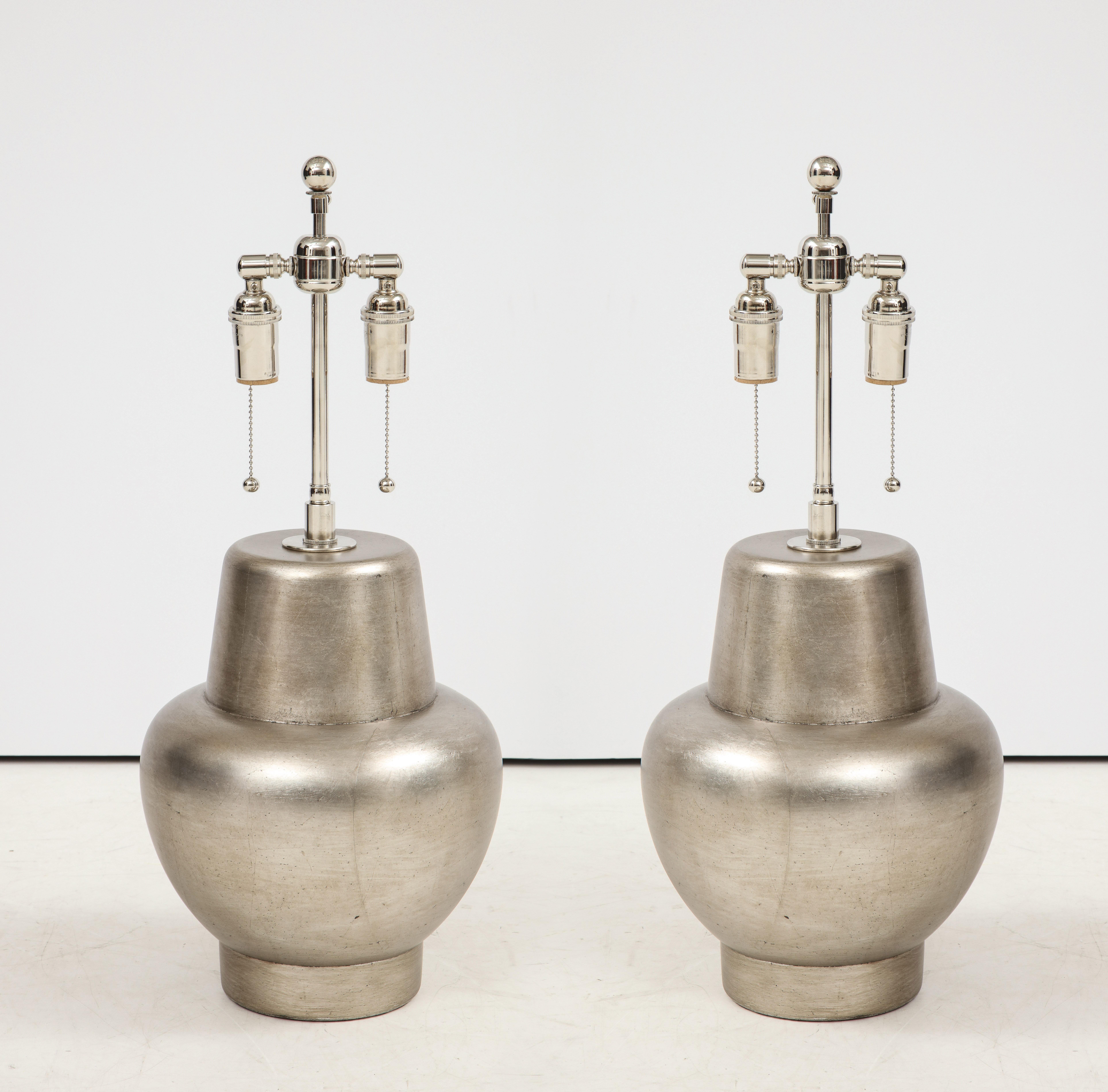 Beautiful pair of glazed silver leafed lamps by James Mont.
The lamps have been newly rewired with polished nickel double clusters.
The price is for the pair
  