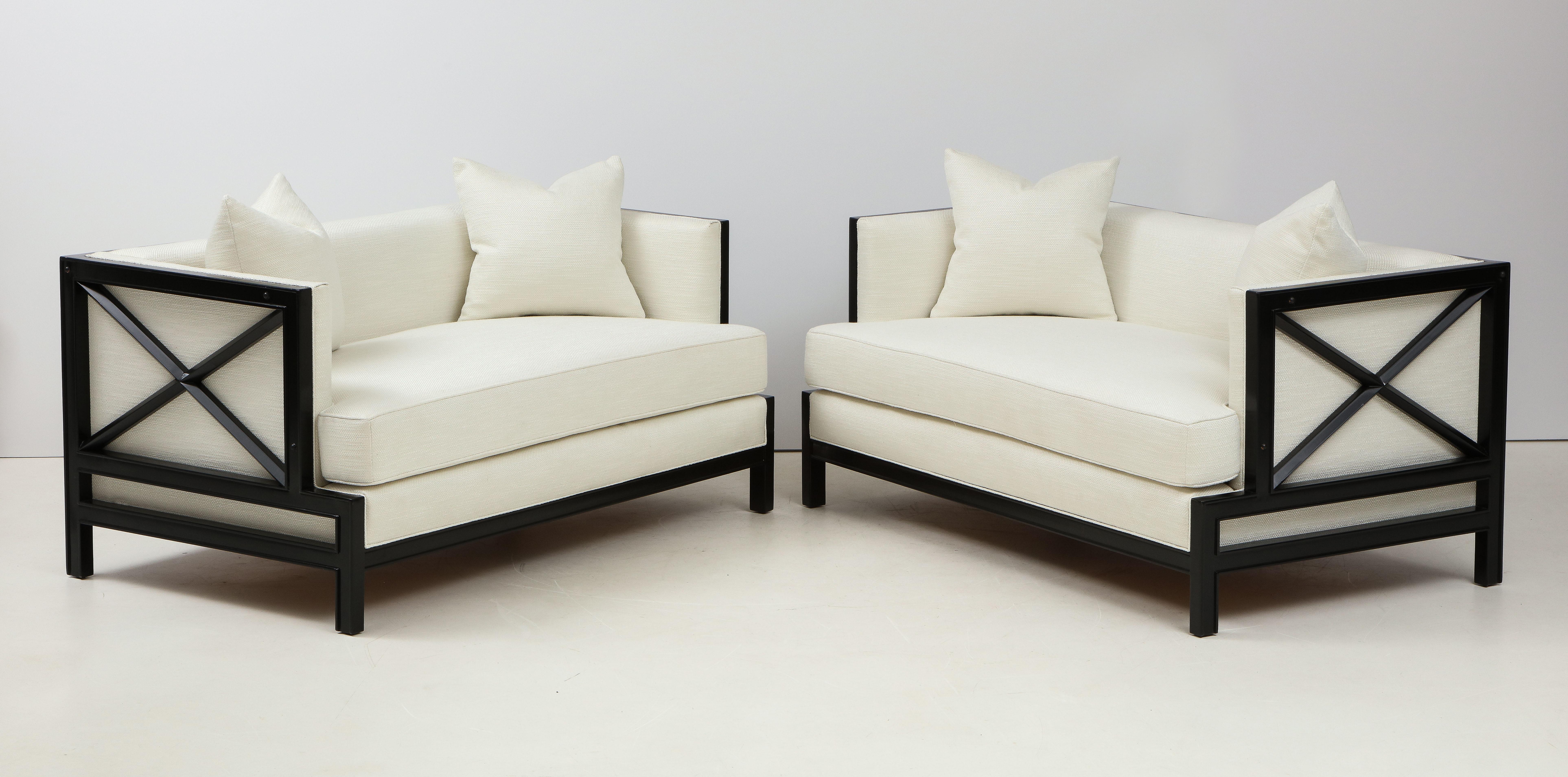 Beautiful James Mont Sofa's.
The elegant Lattice framed Sofa's have been Newly reupholstered in an ivory colored fabric and each sofa has two separate throw pillows.
The Sofa's are featured with a matching Ottoman which is Available for purchase