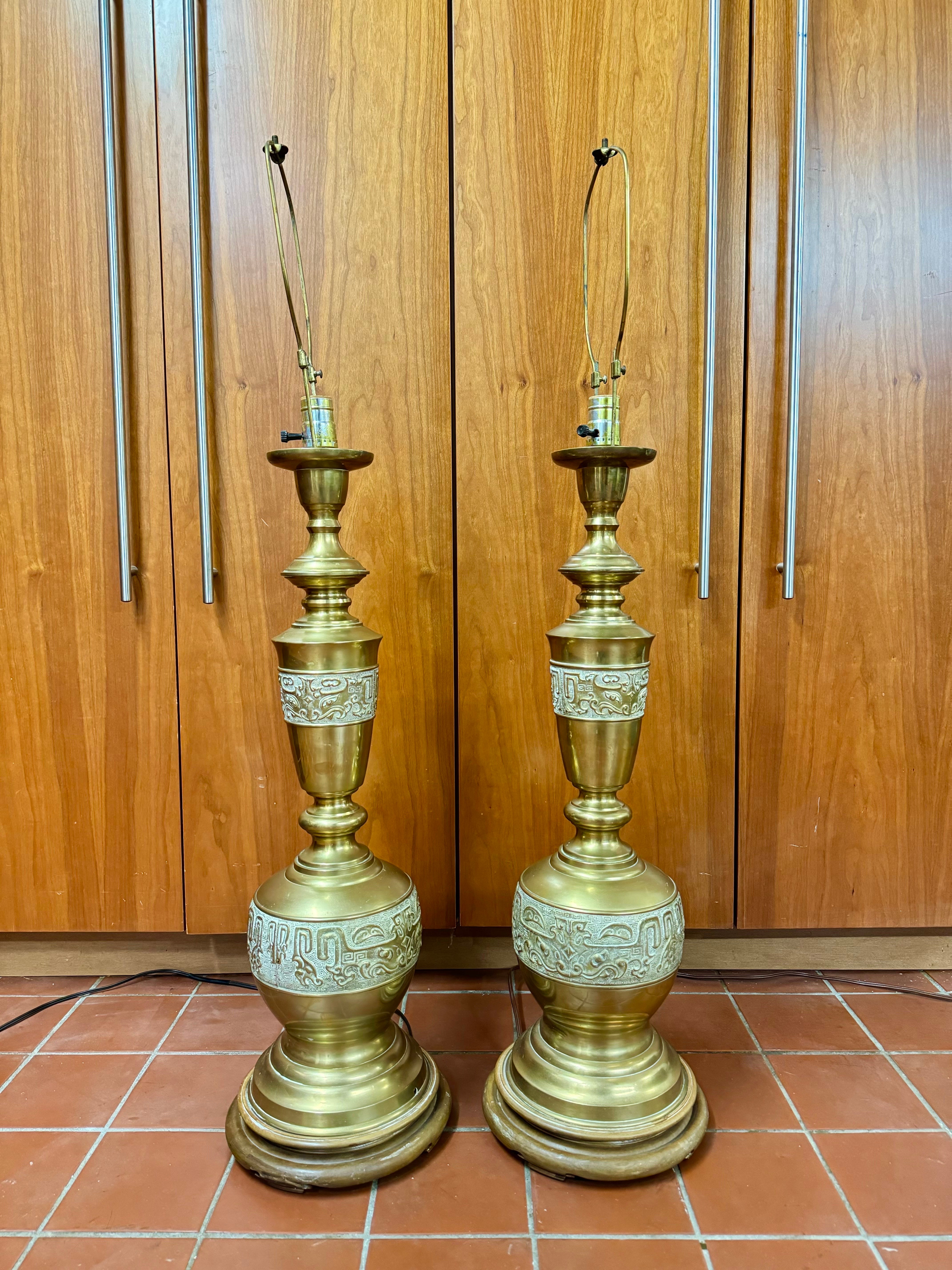 Paire de lampes Chinoiserie en laiton de style James Mont. Motifs asiatiques complexes et détails du design en laiton. De grandes lampes design élégantes qui feront sensation dans n'importe quelle pièce.  Mesure jusqu'à l'embout 39,5