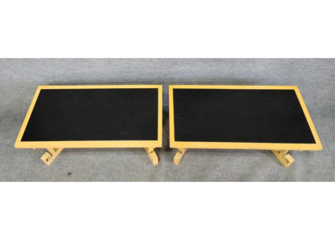 A pair of unique side tables in a mid-century Asian influenced design similar to those of James Mont with a painted wood surface and unique well crafted metal grill inset into the base, a characteristic of Mont designs.
 
James Mont is synonymous