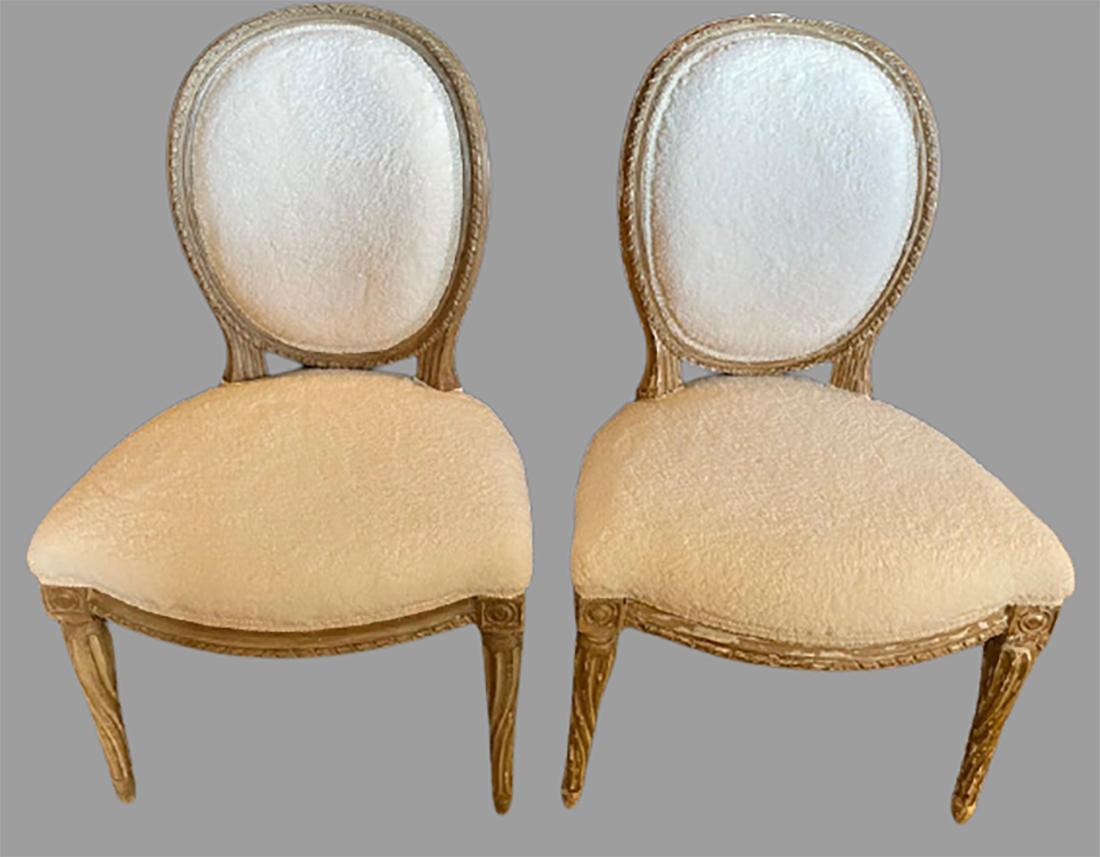 Pair of Jansen distressed Sherpa upholstered side chairs. Each having a cameo back on a distressed from worn and beaten in new Sherpa like fabric. The pair with fine twisted reeded legs.