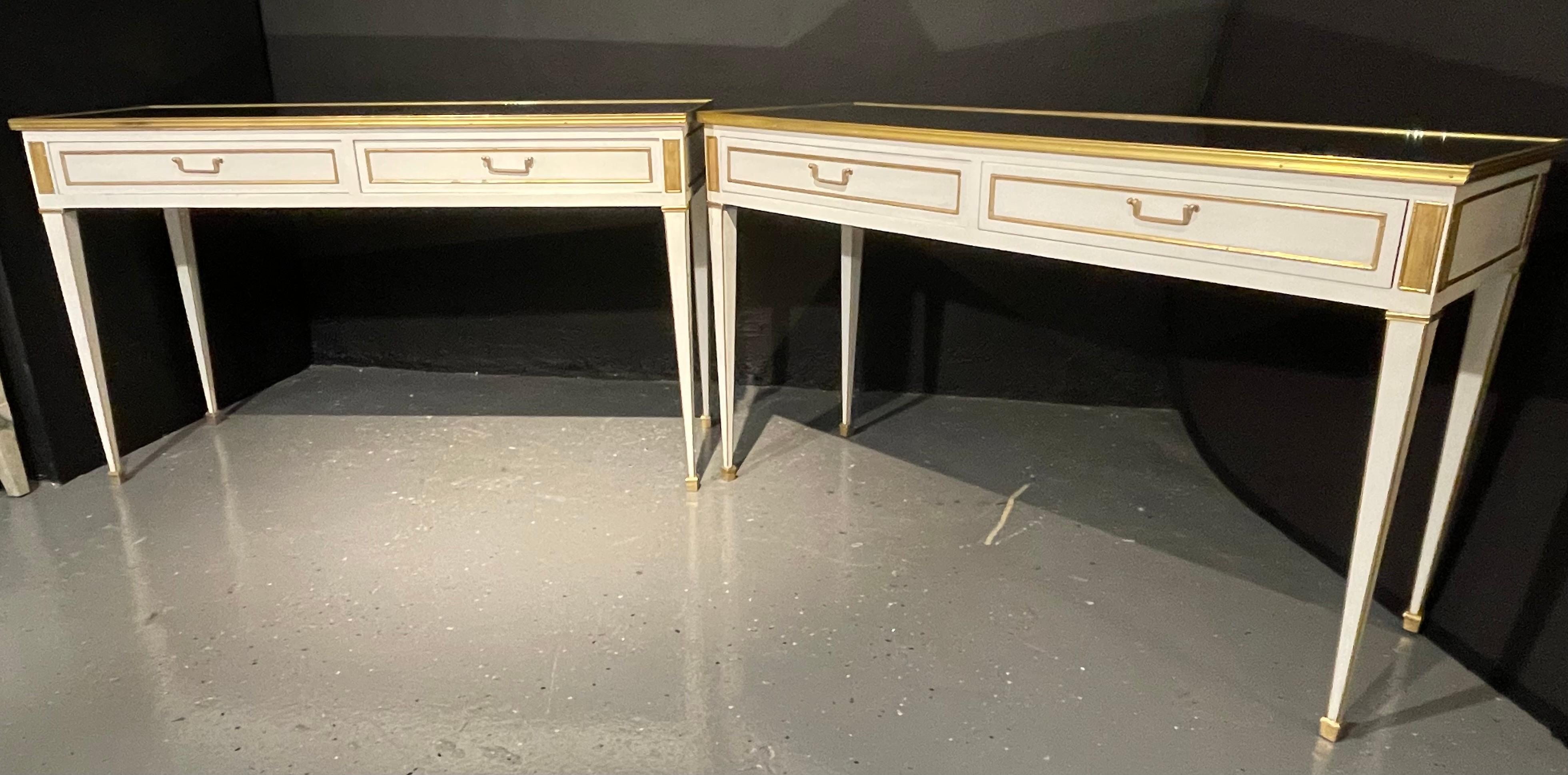 Pair of console or sofa tables each having a clean mirrored top set in a bronze frame supported by an apron sporting two drawers each bronze mounted with bronze drawer pulls and bronze cookie cutter corners. The pair having matching apron sides. The