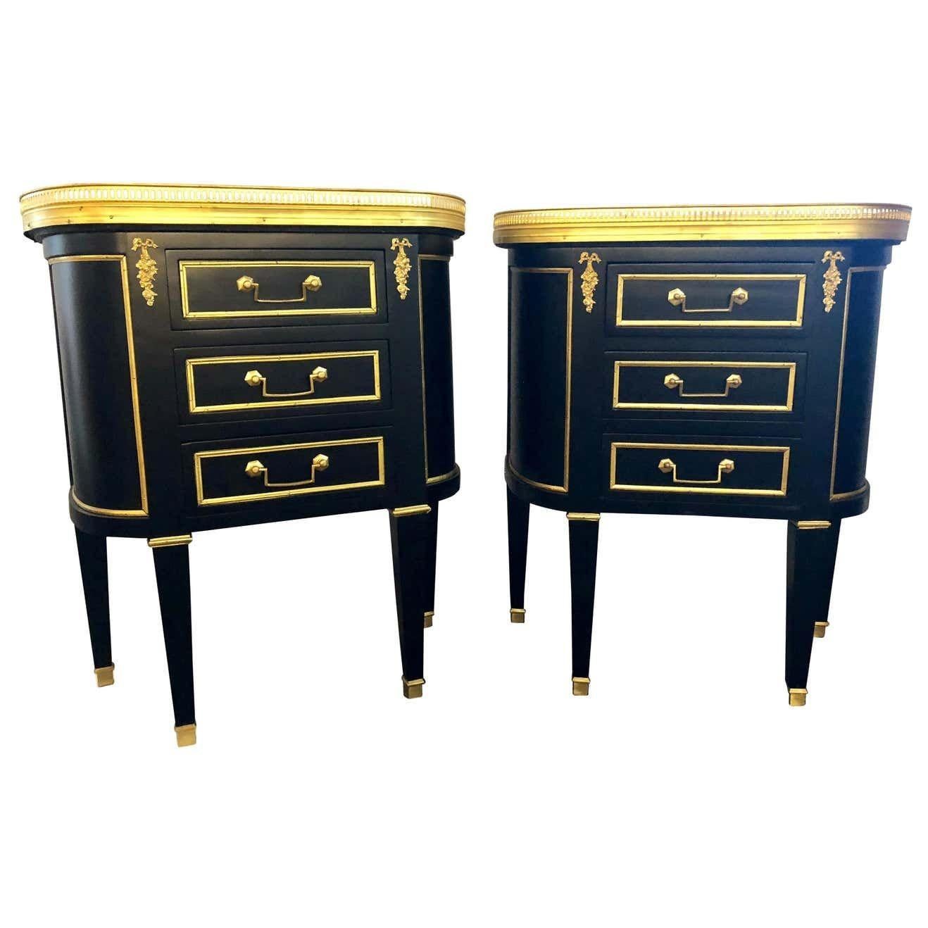 Maison Jansen inspired marble-top galleried ebonized end tables and or nightstands with three drawers.
Pair of Jansen inspired marble-top galleried ebonized end tables and or nightstands with three drawers. These Hollywood Regency end tables will