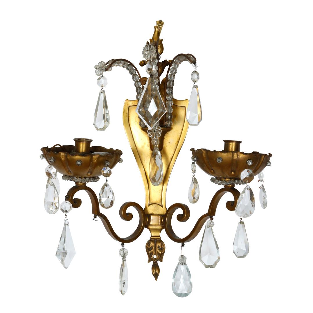 Pair of Jansen style two arm bronze sconces with hanging crystal prisms.