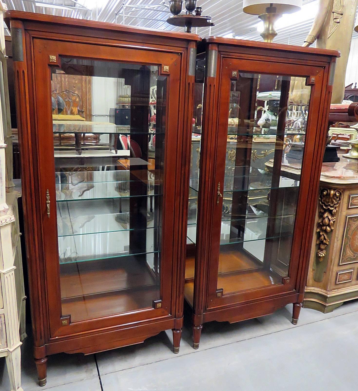 Pair of Jansen style display cabinets. Each has three glass shelves and bronze mounts.