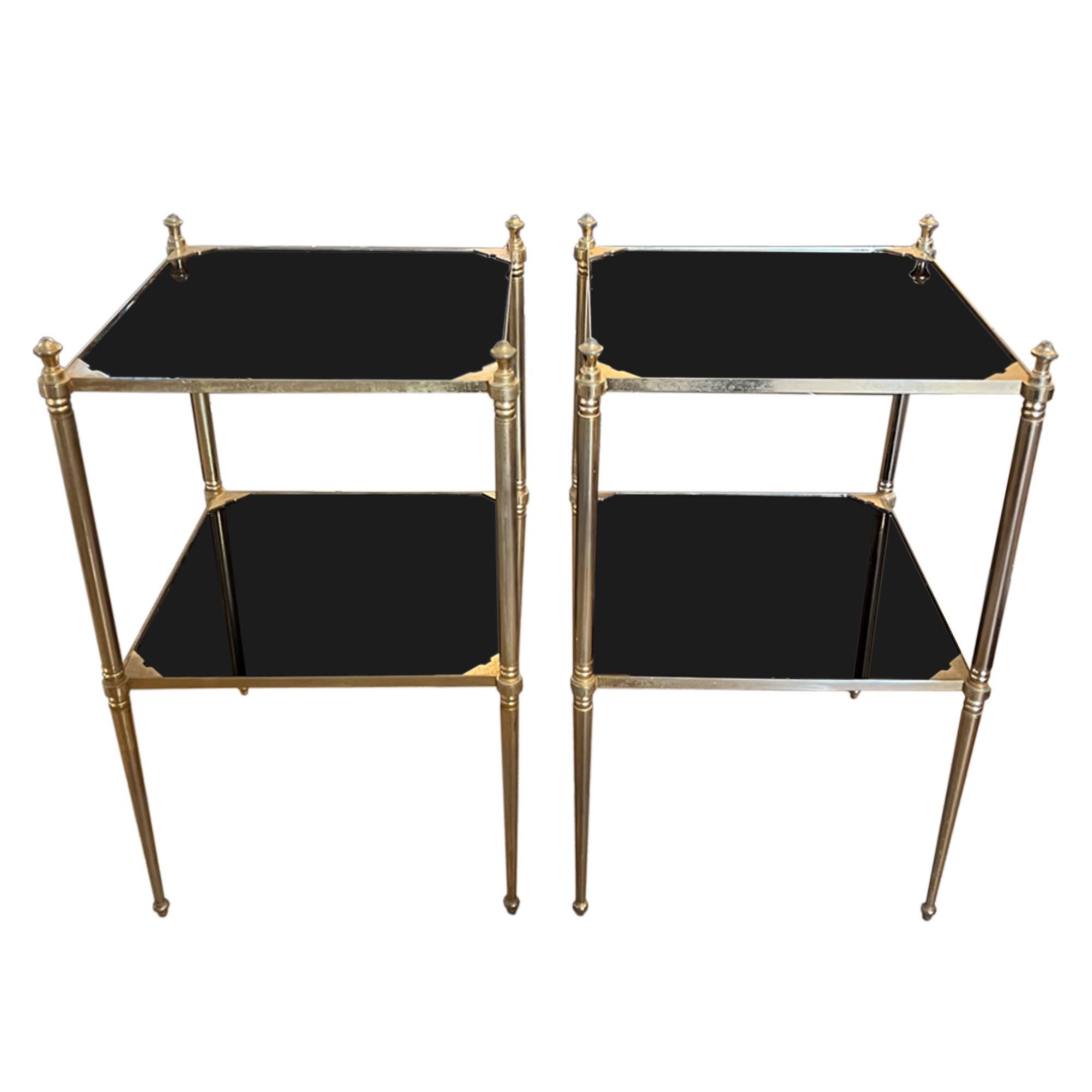 This is a super stylish pair of Jansen style midcentury side tables.

Made in France from gilt metal and black glass. A simple design, but with a very elegant finish - take a look at the edging on the glass and the tapering legs.

Classic French