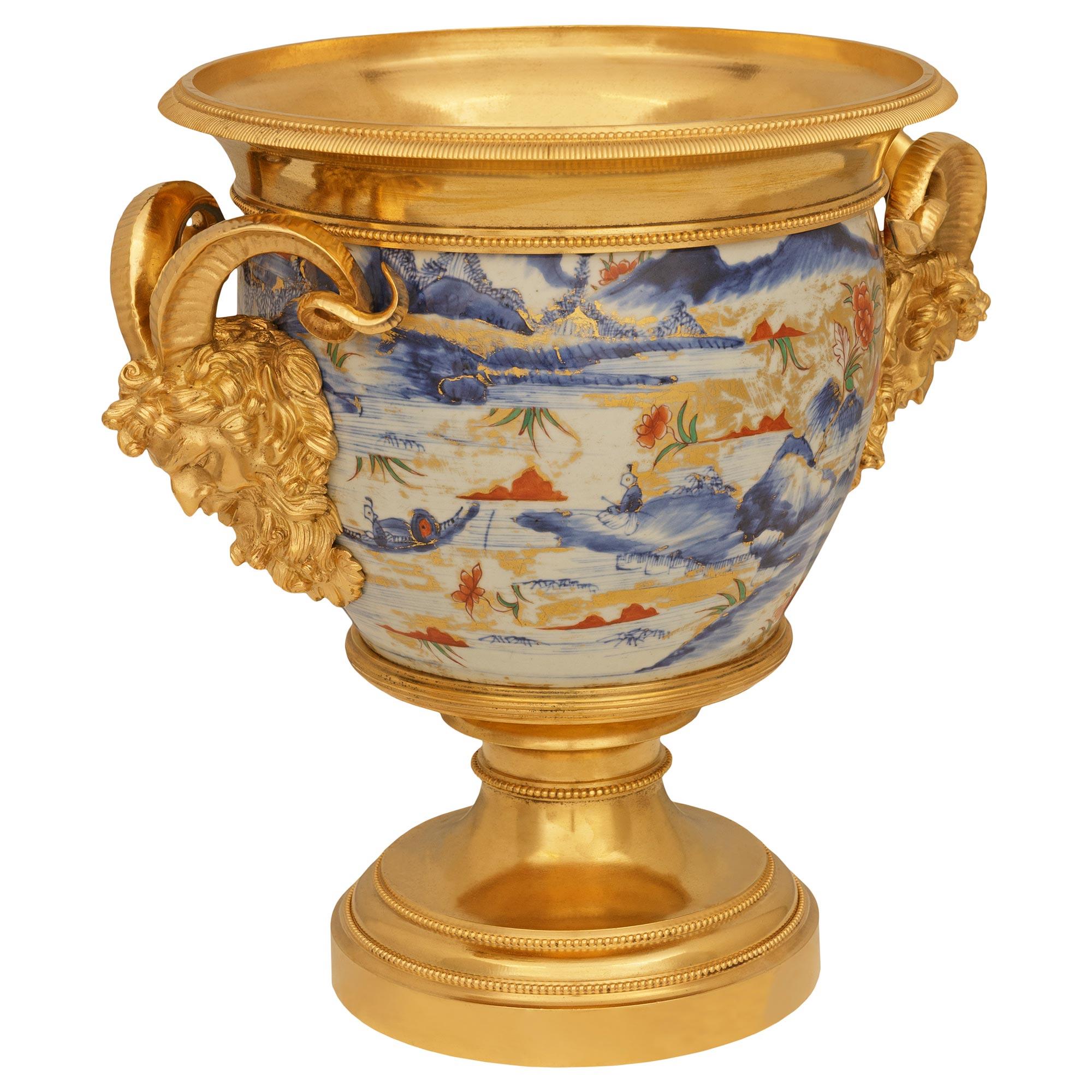 A high quality and most stunning pair of Japanese 18th century Imari Porcelain and French Louis XVI st. Ormolu mounted urns. This wonderful pair of urns are raised by Ormolu socles decorated with beaded borders leading up to the cup which supports