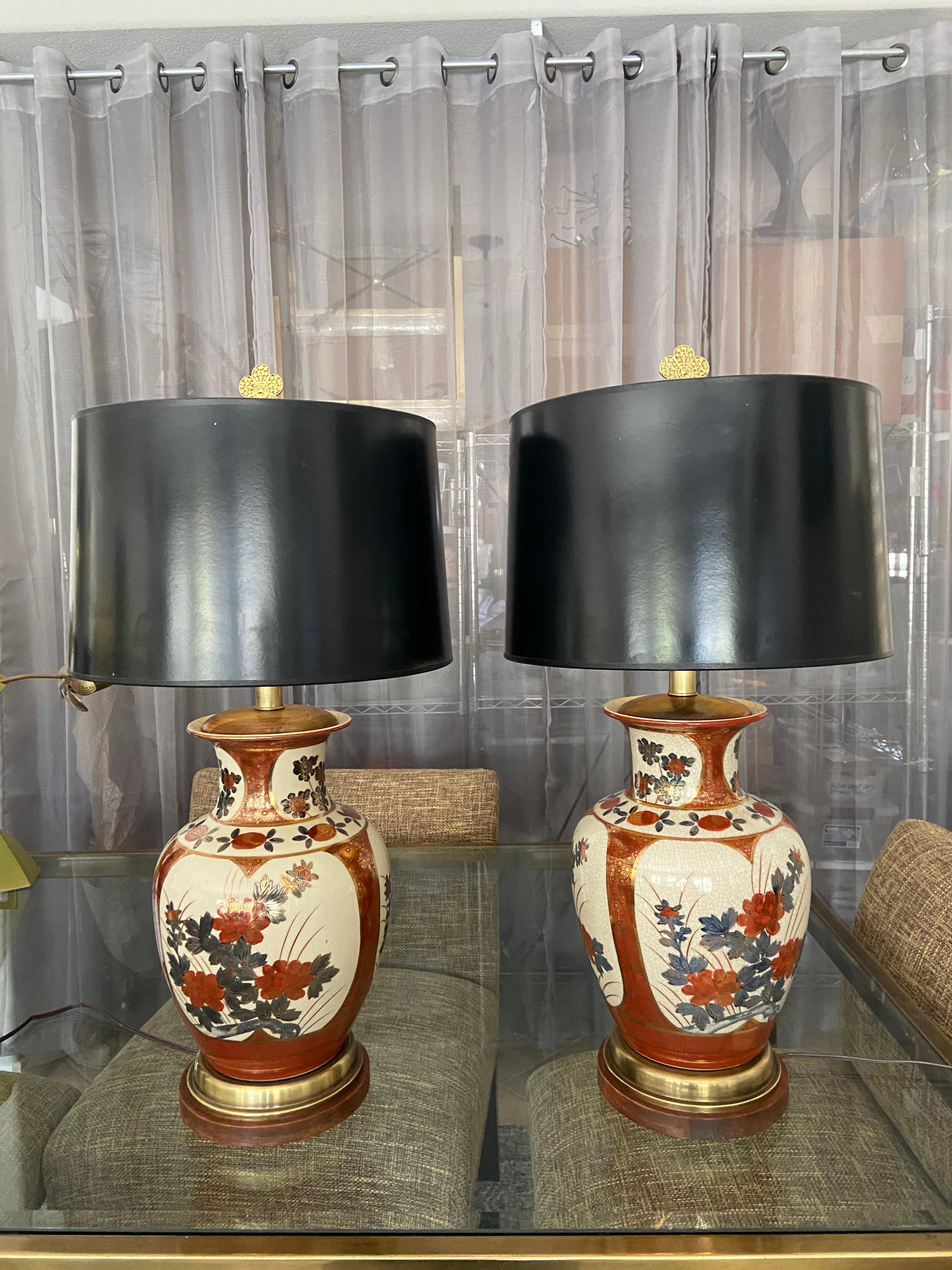 Pair of Japanese Imari porcelain crackle finish vases mounted on original custom brass and wood bases. The colors are a rich burnt orange and soft blue with gold outlining, the design is a classic flower and leaf motif. Originally made by Frederick