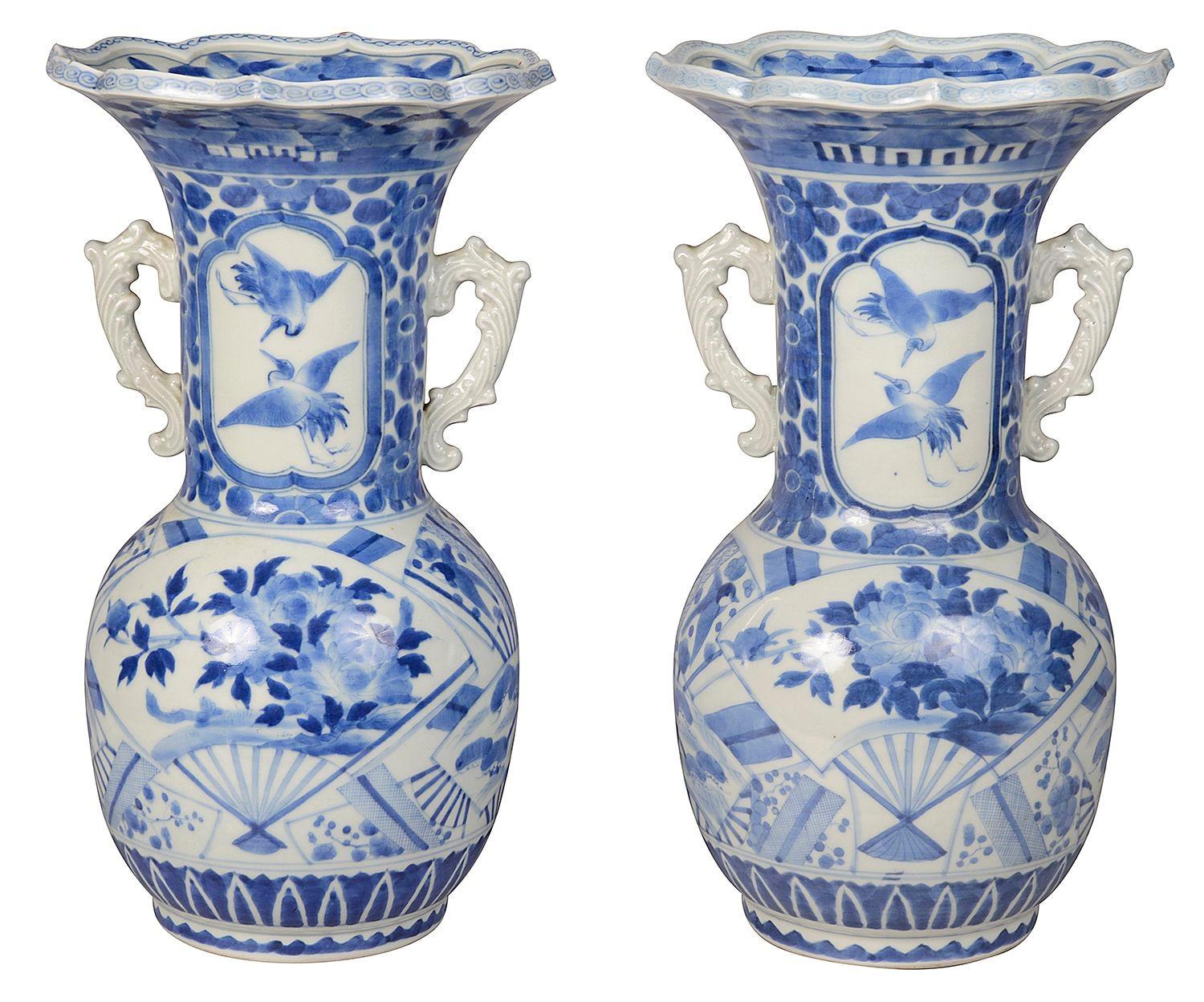 A good quality decorative pair of 19th Century Blue and White Japanese, Meiji period (1868-1912) porcelain vases / lamps, each with flared necks, classical motif decoration to the ground, pairs of handles either side, inset hand painted panels