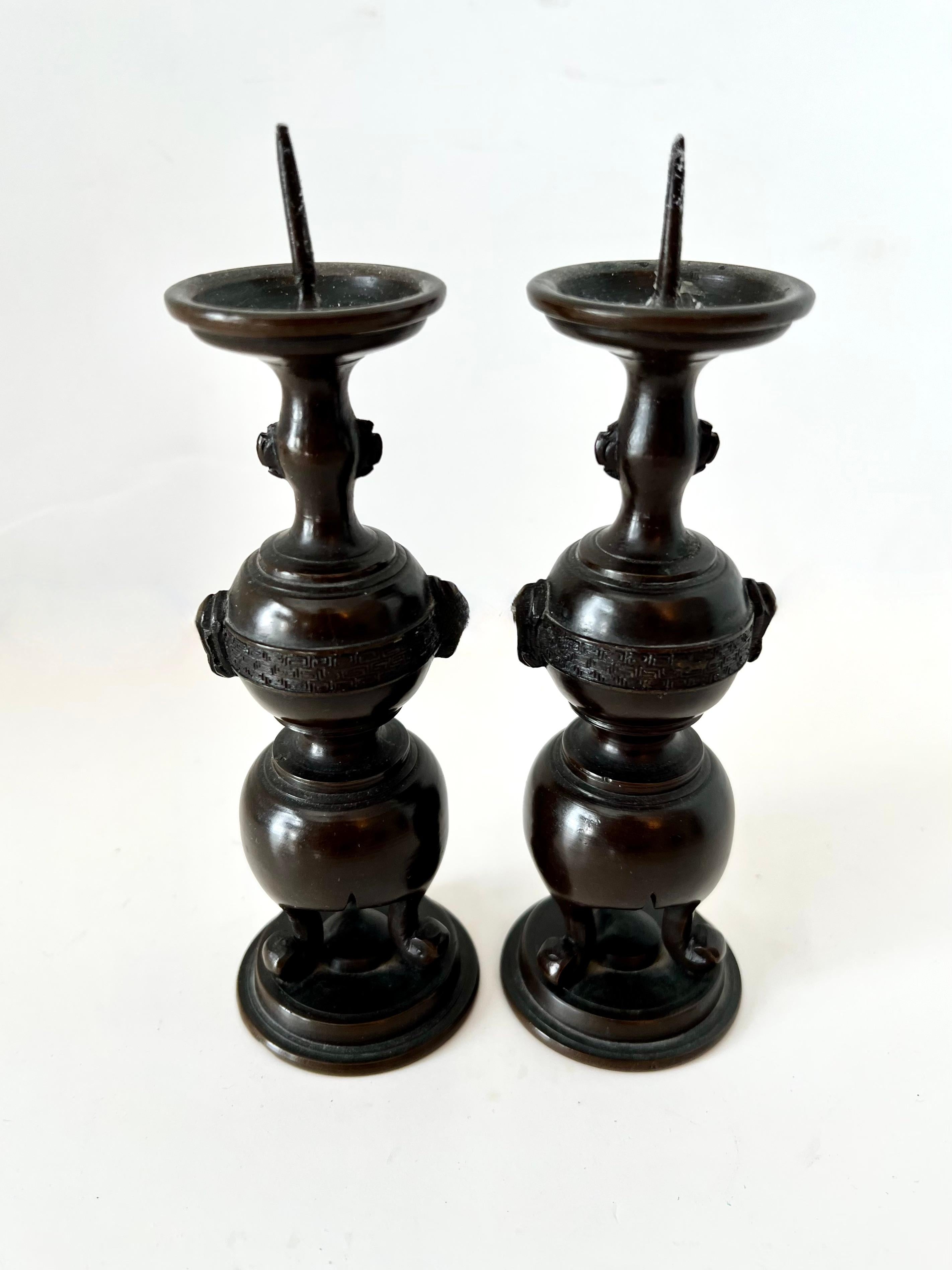 A wonderful pair of Japanese Bronze Candlesticks.  The pair make a lovely pair for a small dining table or on a side table, mantle or shelf.

In the Style of Meiji Period with a patinated bronze - 
