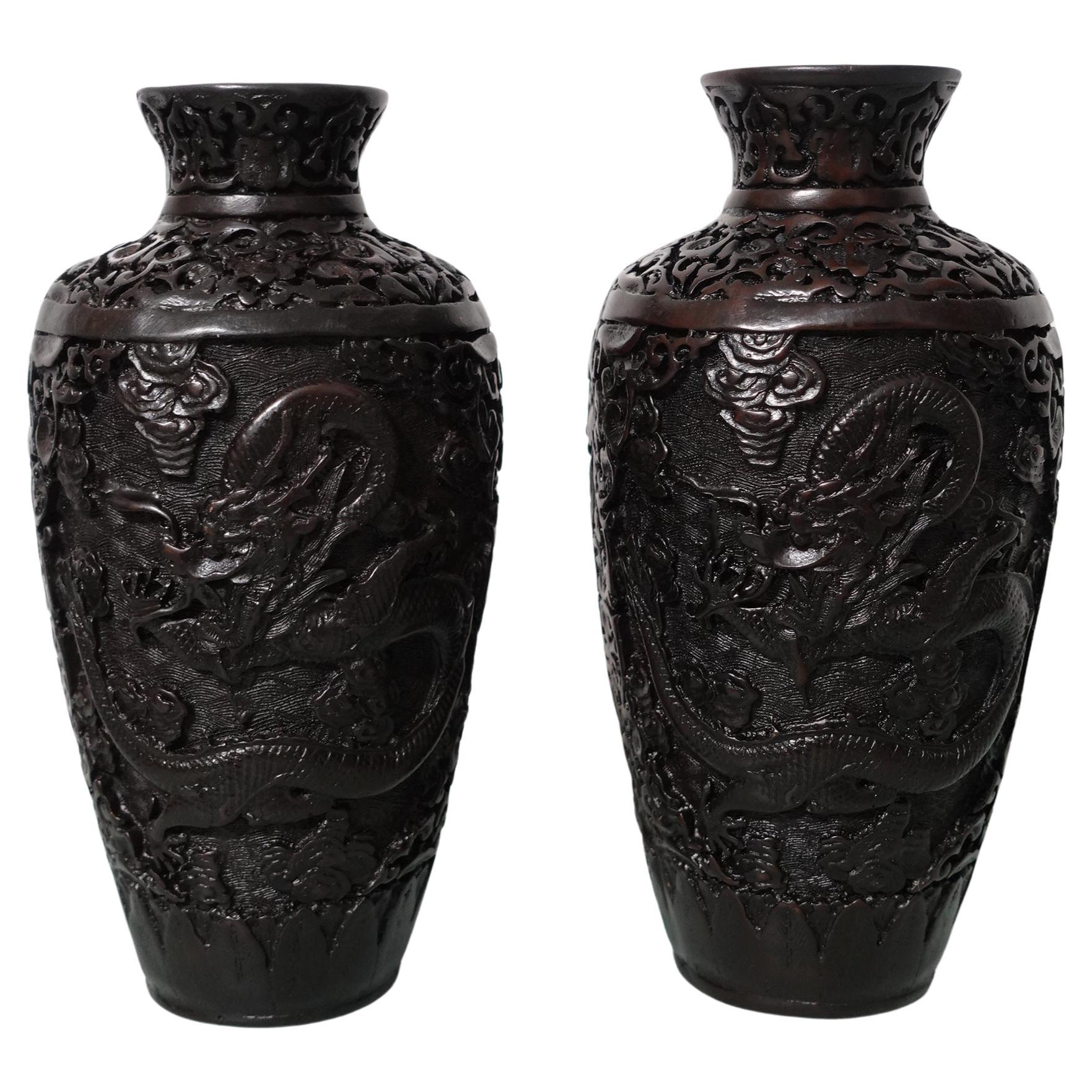 Carved Metal all over with large reserves on two sides of a dragon chasing a flaming pearl. With all-over floral and bat patterns.