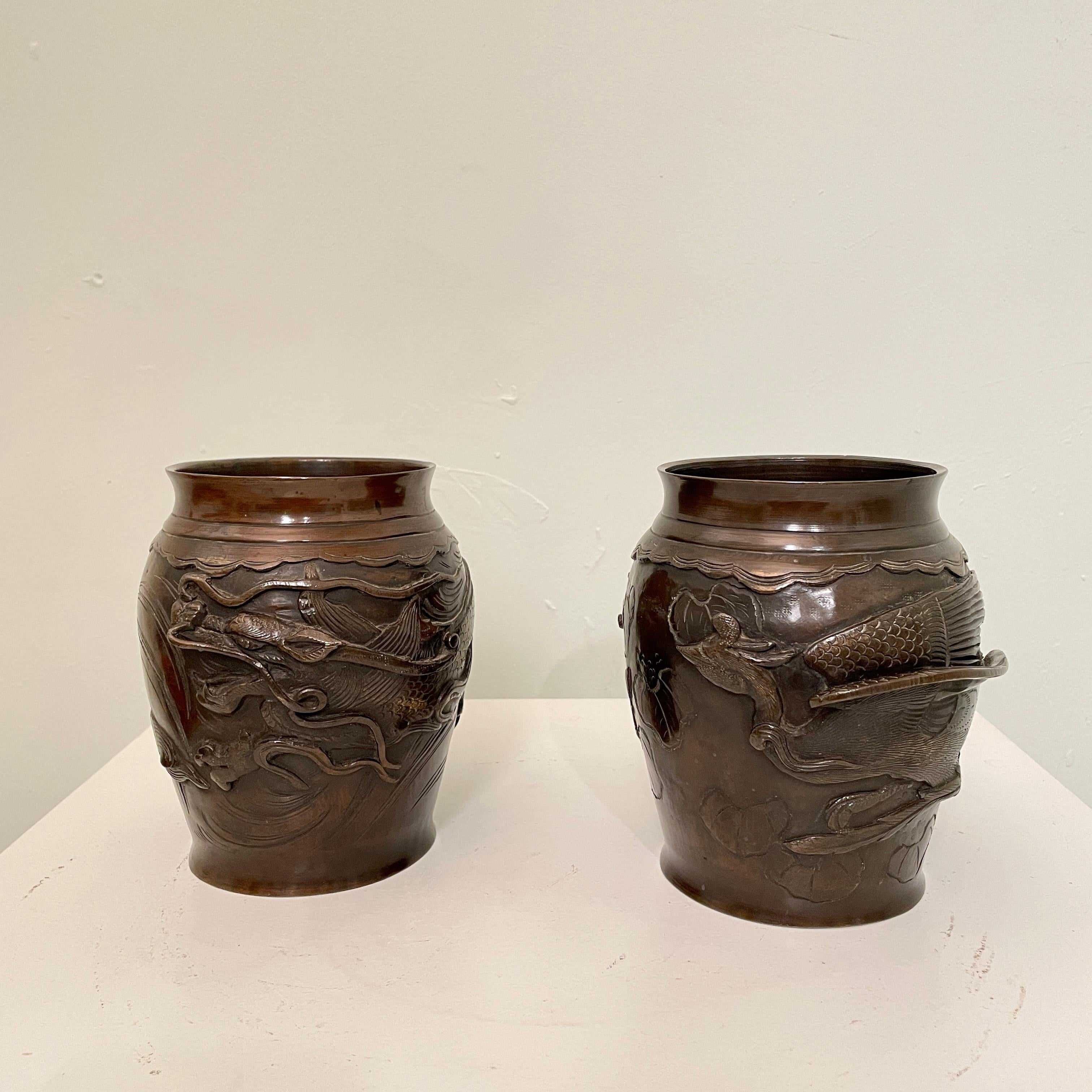 This beautiful Pair of Japanese cast bronze vases with high relief Dragon and bird figure was made around 1880.
The high relief cast decoration of a three-clawed dragon is wrapped around the body of one vase and the other one got a bird.
 This