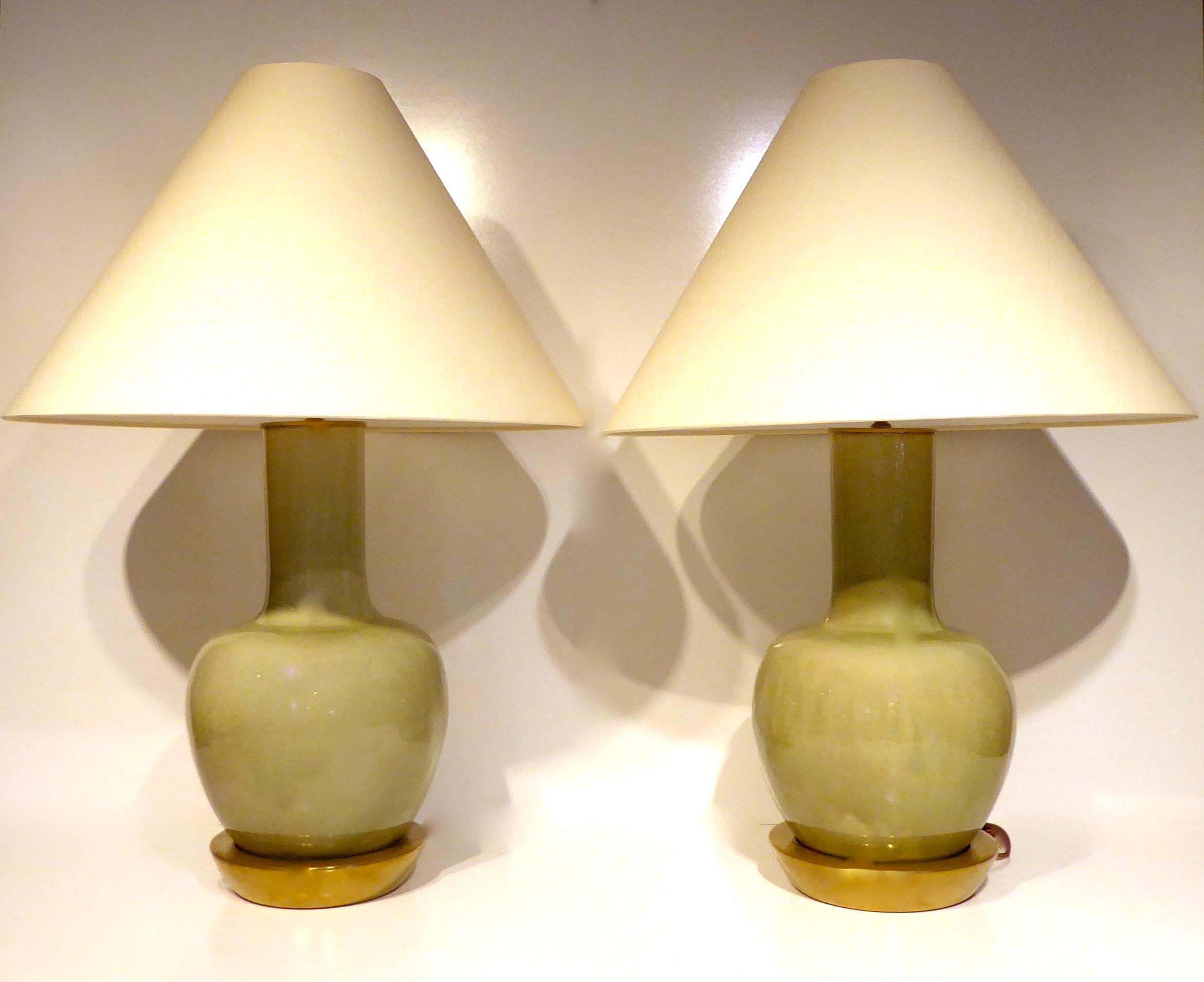 A pair of gourd-shaped Japanese celadon glazed porcelain lamps, circa 1950s. The lamps retain their original bases, which have been recently brass-coated to match the hardware. One of the lamps had an old, faded label that said 