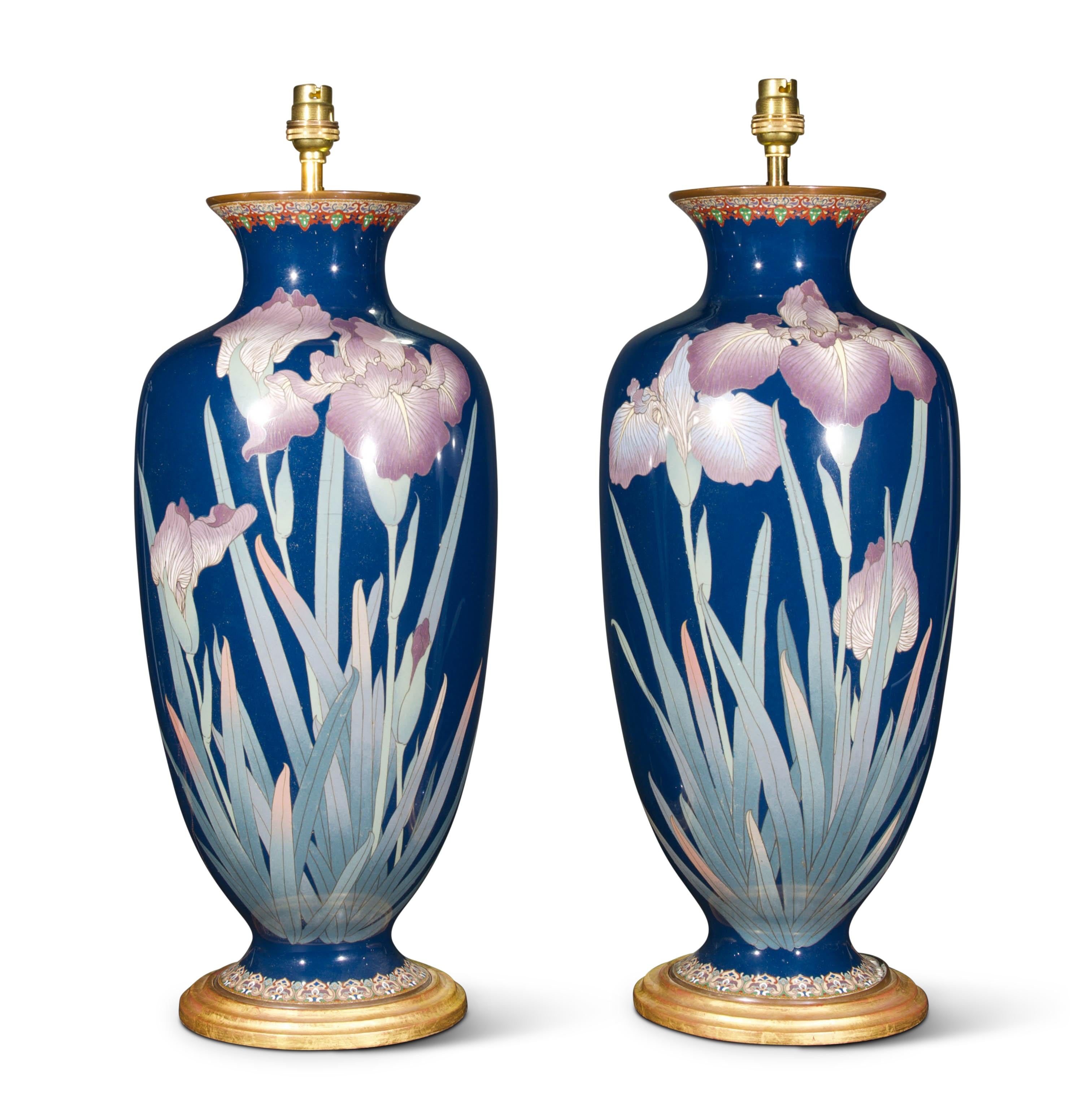 A fine pair of large Japanese Meiji period cloisonné enamel baluster vases, decorated with wonderful irises on a deep blue ground, now mounted as lamps each with a hand-gilded turned base.

Height of vases: 19 1/4 in (49 cm) including gilt base,