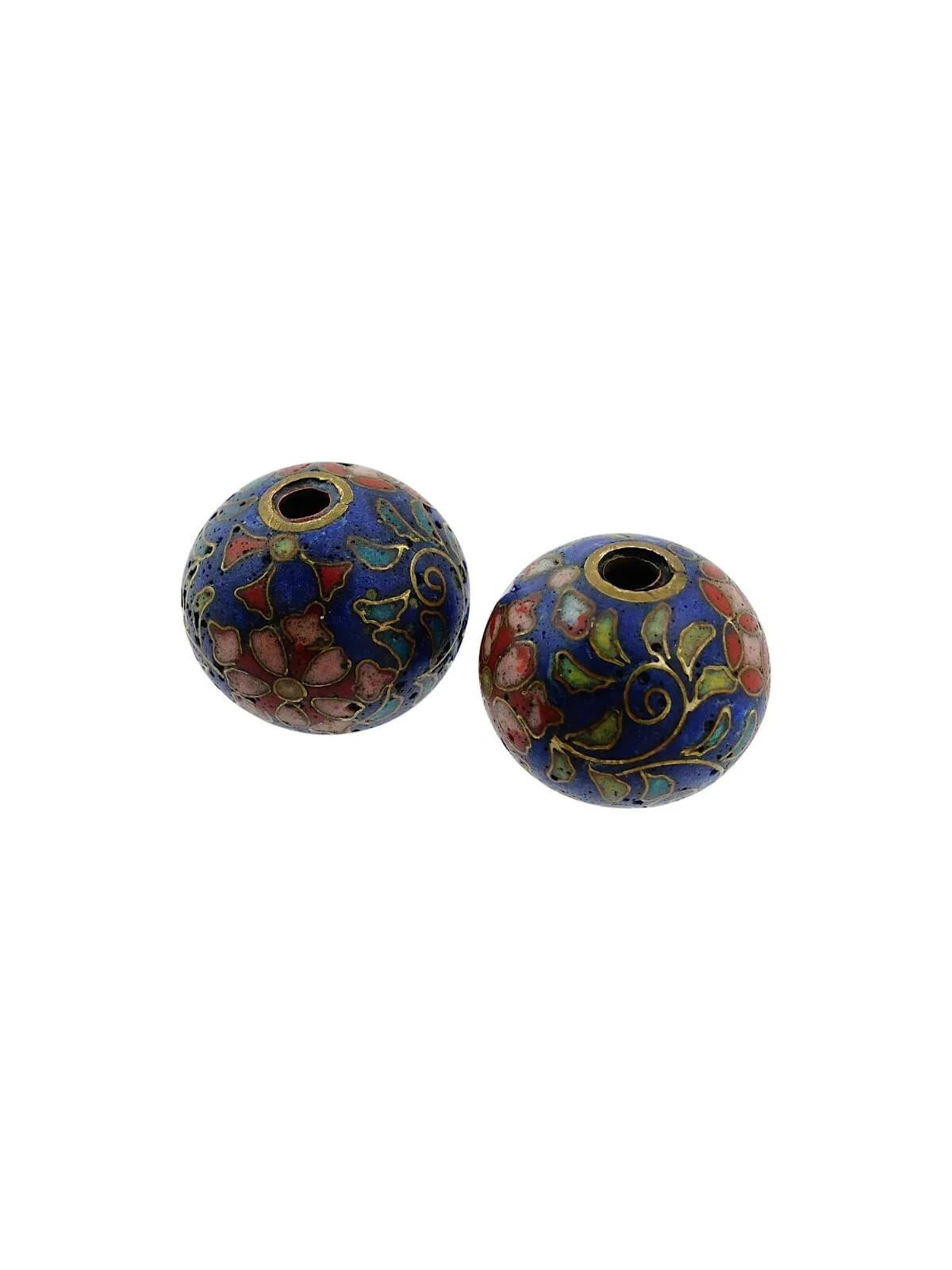 A pair of Japanese enamel Ojime beads. The circular shaped beads are adorned with polychrome floral, foliage and geometrical patterns made in the Cloisonne technique. Antique and Vintage Asian Beads and Accessories For Collectors.
Dimensions: 1/2 x