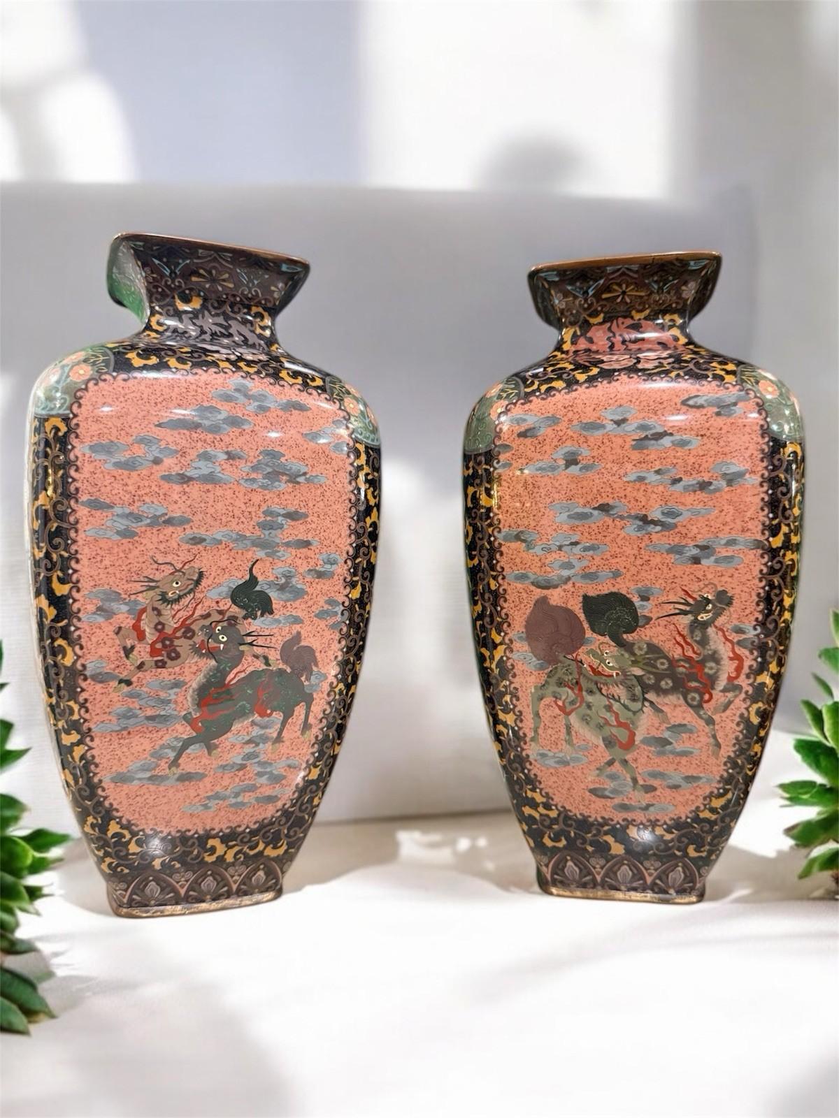 A superb pair of Japanese cloisonné vases from the Meiji period, each finely worked in silver wire and rising 12 inches high.


The four-paneled design alternates between mythological and natural themes: kirin and tigers against soft peach grounds,