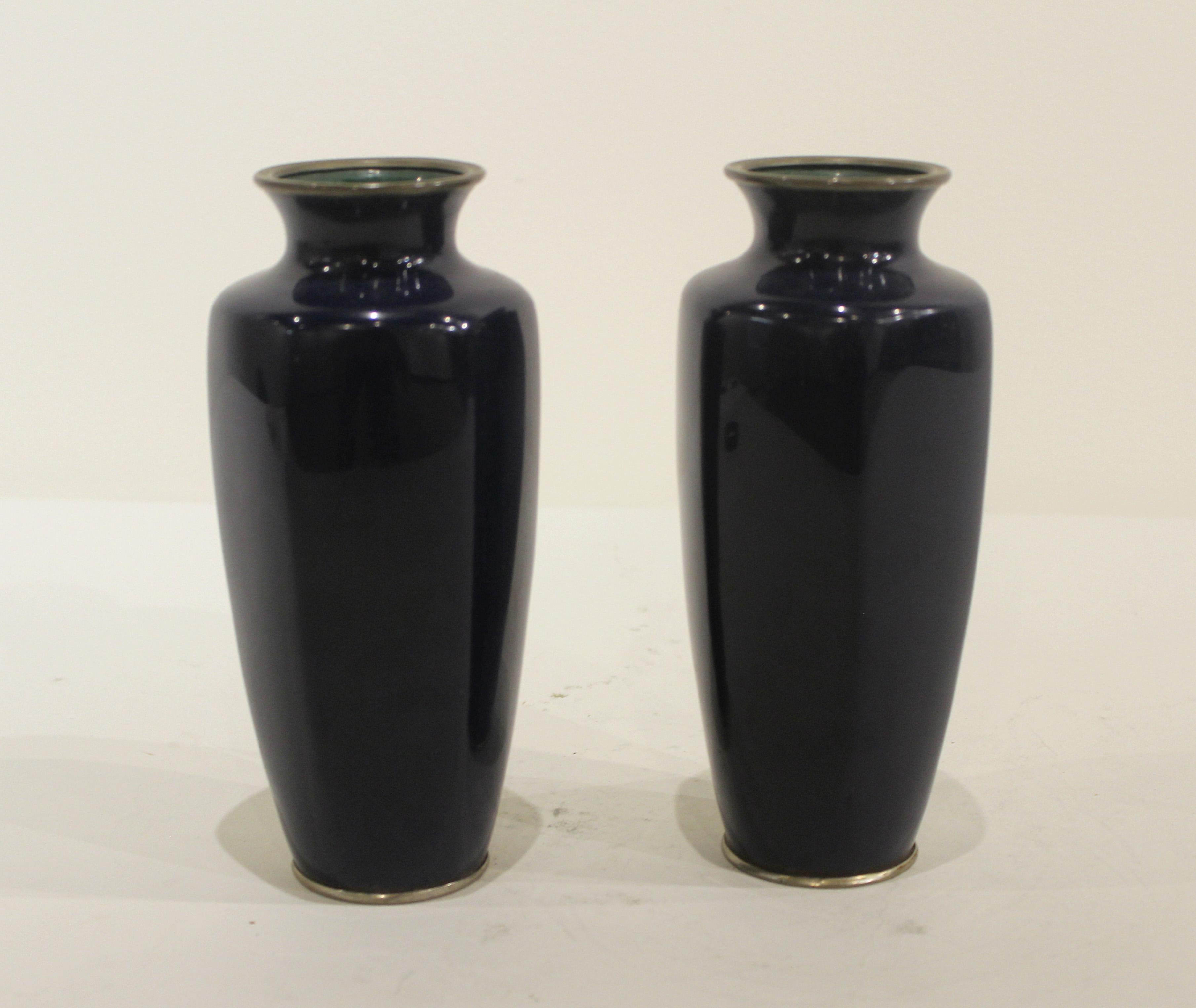 Pair of Early 20th Century Japanese Cloisonne Vases with birds and flowers on cobalt blue background.