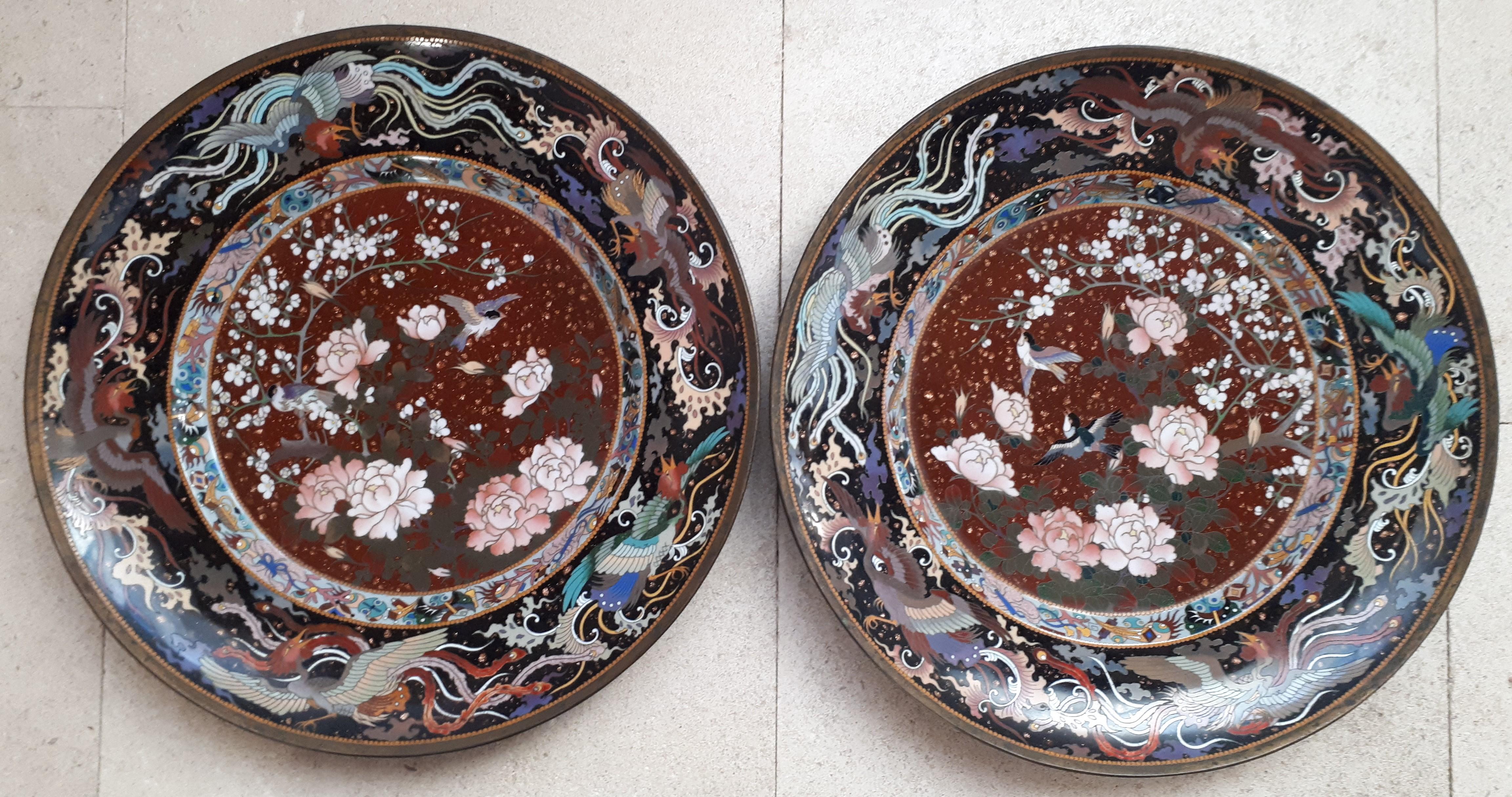 Pair of very finely cloisonné bronze and enamel dishes decorated with birds and flowers on a background with copper and gold inclusions. The wings of the dishes adorned with flying phoenixes. Note that these dishes are much more beautiful in real