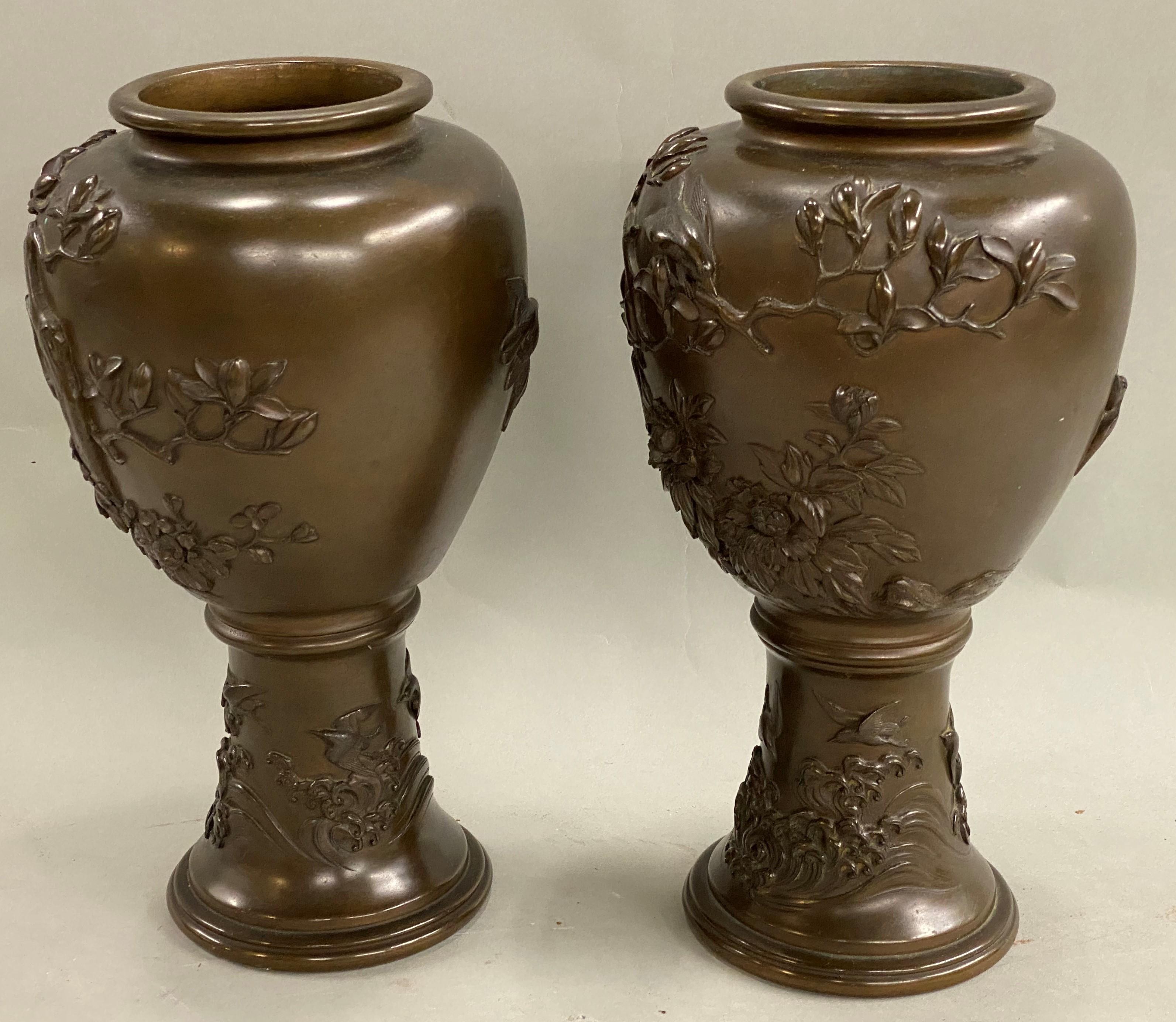 An attractive pair of Japanese Edo Period bronze vases with relief foliate and bird decoration, probably dating to the early 19th century, in very good overall condition, with minimal surface imperfections and wear commensurate with age and use. The