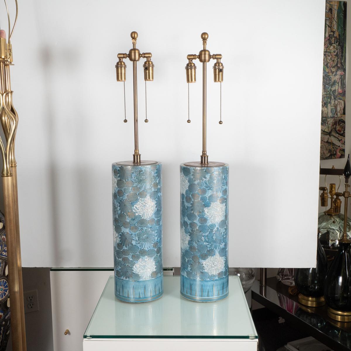 Pair of blue ceramic table lamps with hand painted Japanese chrysanthemum flower motif.