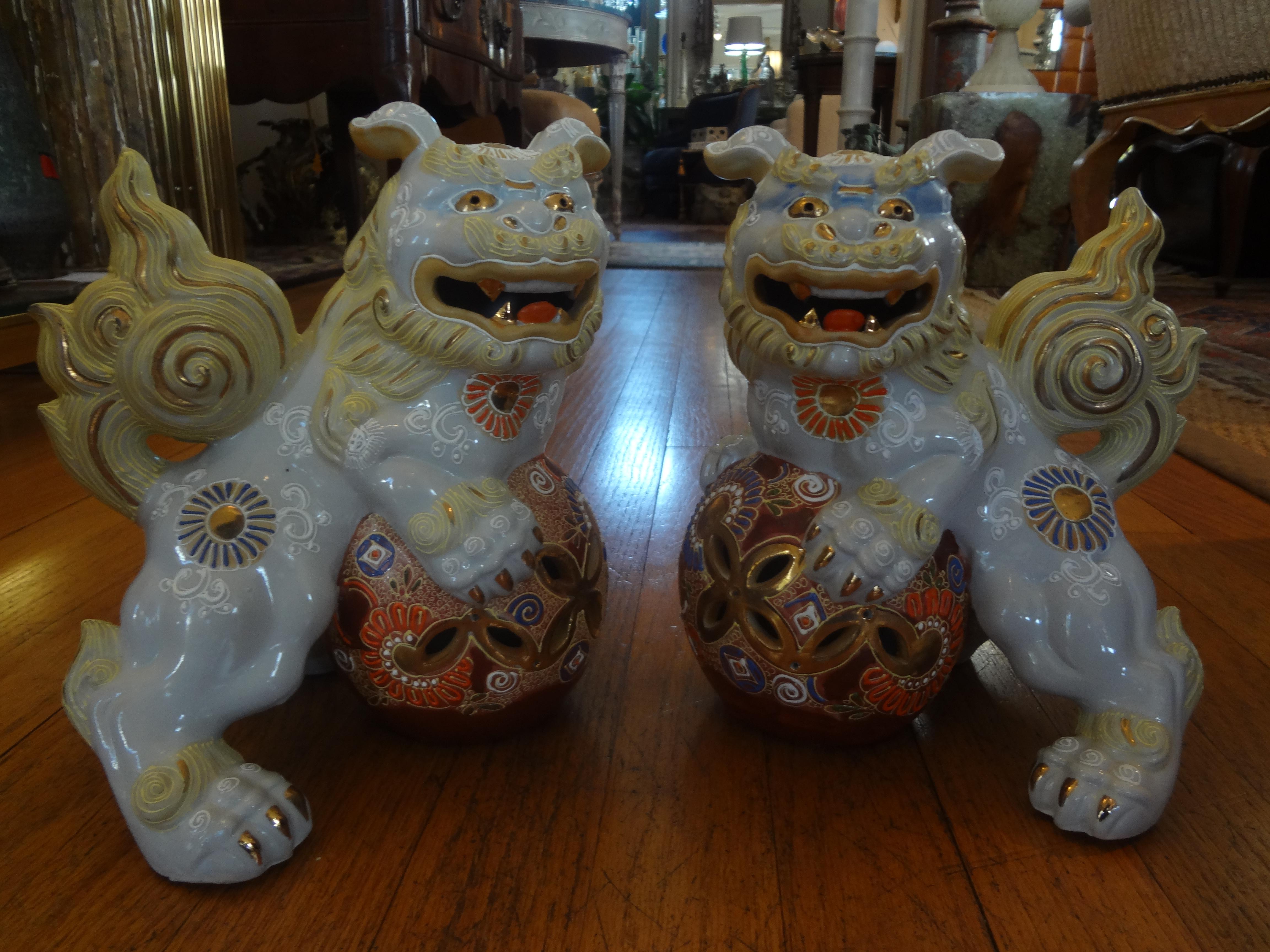Pair of Japanese glazed porcelain foo dogs. These beautiful Japanese foo dogs or foo lions are the perfect accessory for a cocktail table or book shelf. Great colors and size!.