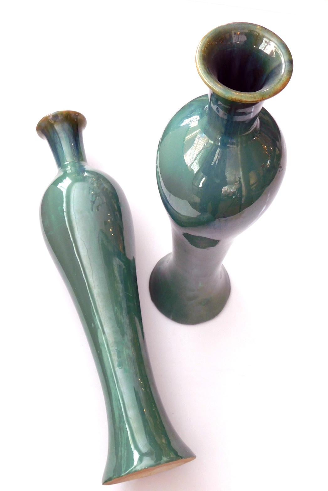 Each doki (earthenware) vase of shapely sensual baluster form covered in a rich celadon drip glaze ending at the foot; each marked to underside.