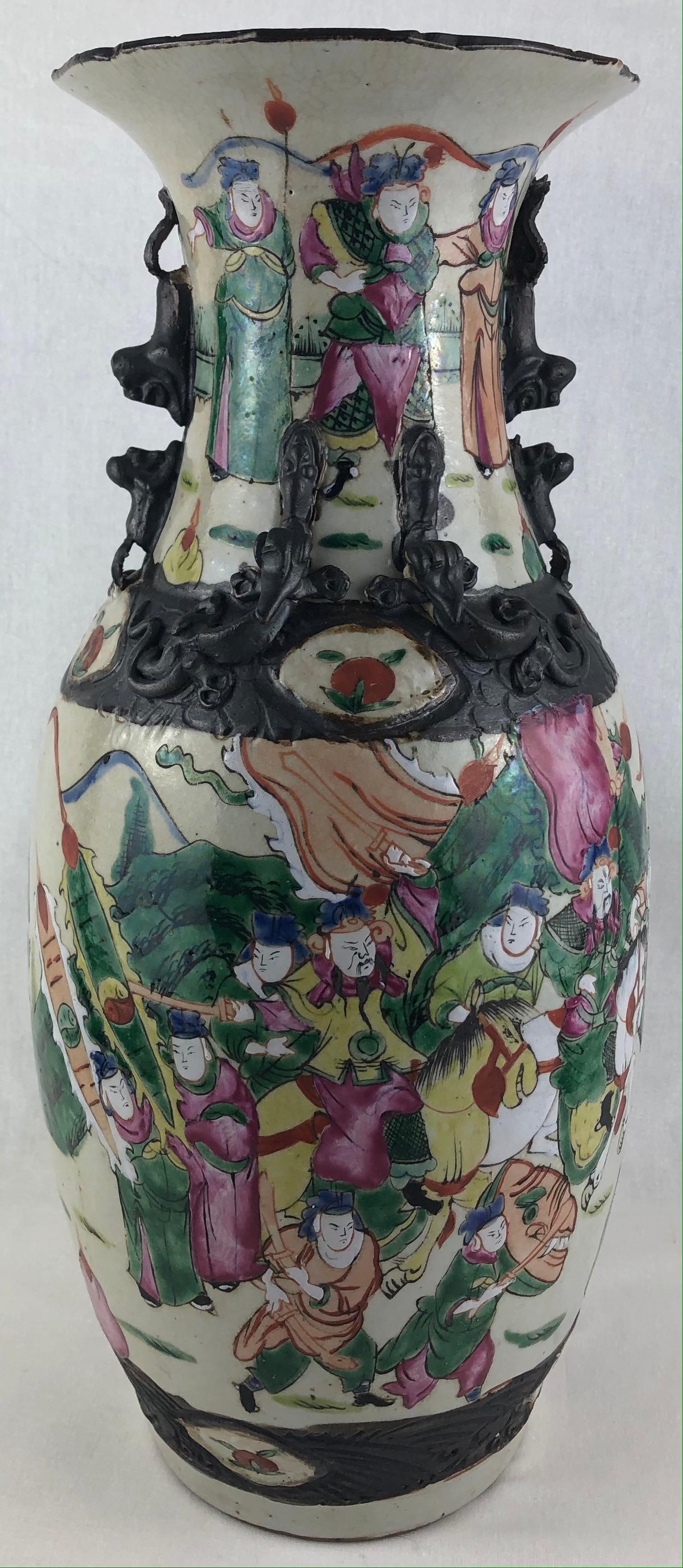 Very decorative pair of Japanese crackle ware poly chrome warrior motif vases with high relief foo lions. Each piece is signed on the underside and have slight variances. Hand painted in a multitude of colors including purple, green, orange, white,