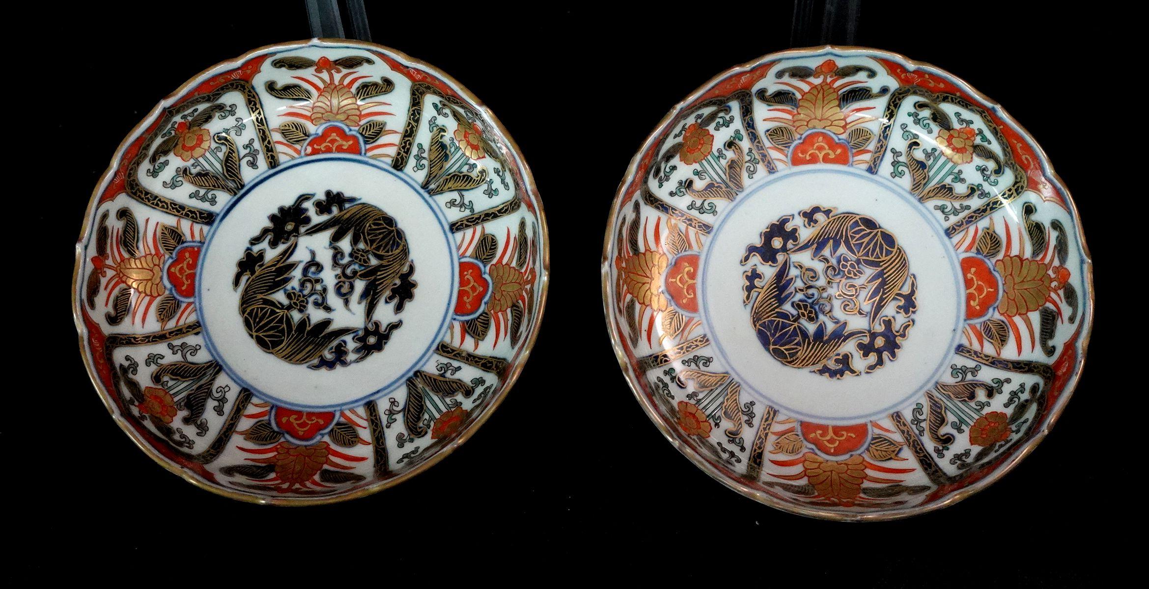 A Pair of Japanese Imari Plates from the Maji period of the 19th Century with different gilt floral designs in 8 different patterns surrounding the entire plater and a painting of mythological painting dominating the center part forming the typical