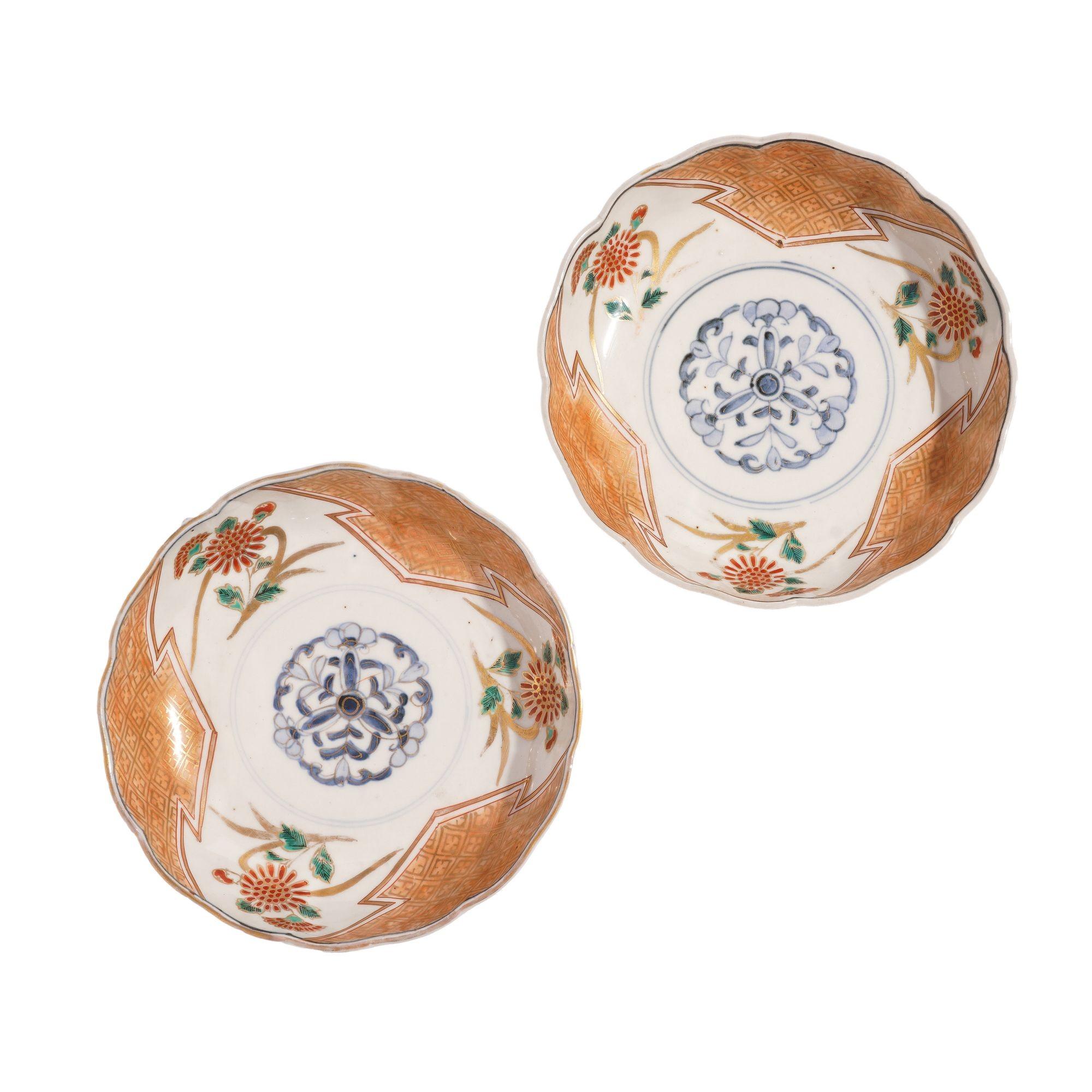 Pair of Japanese porcelain footed bowls in red, green, and blue, highlighted with gold decoration. The decoration centers on a cobalt under glaze central medallion the Imari taste. On the under foot are four Chinese character marks in cobalt blue,