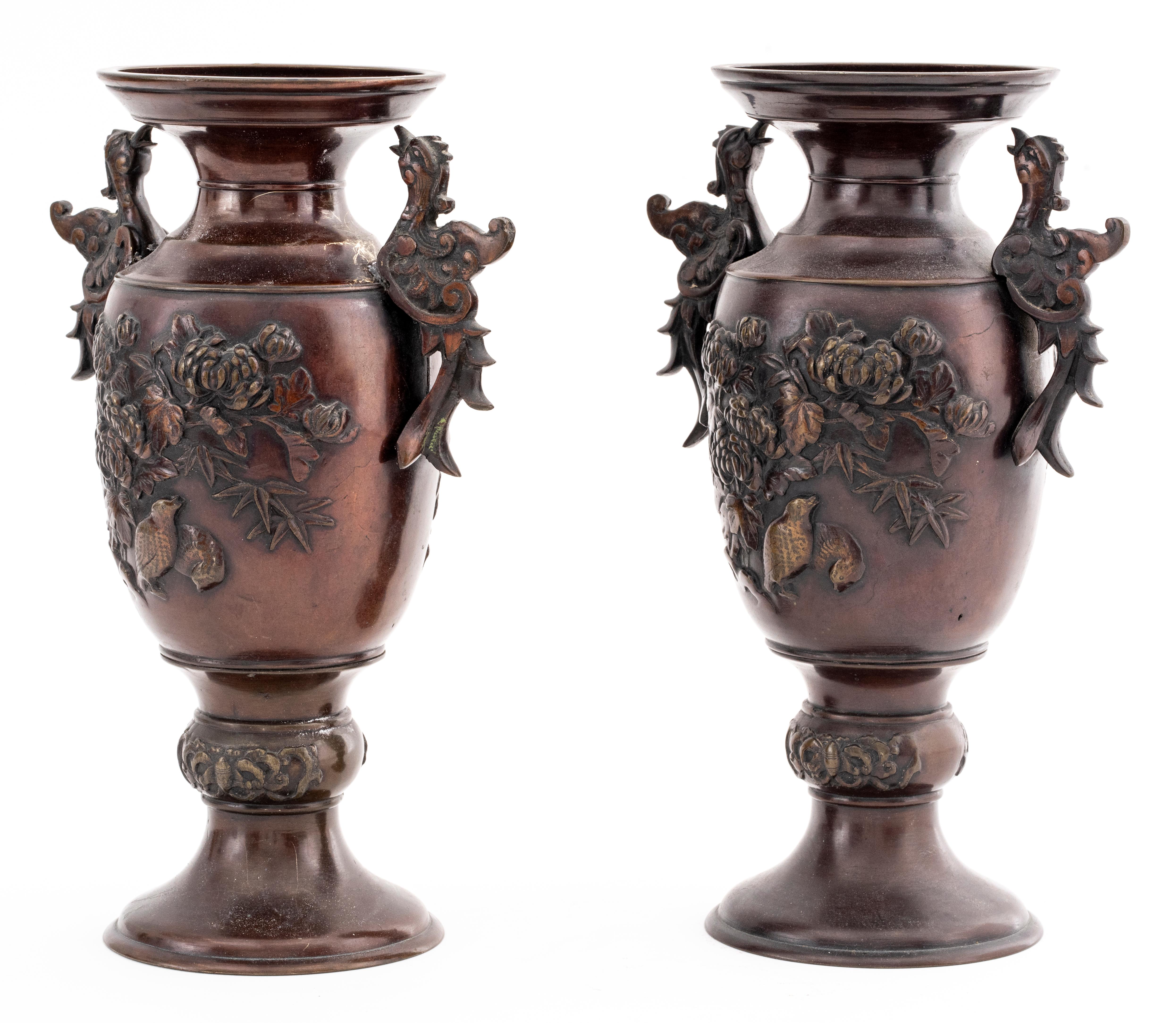 Pair of Japanese Meiji bronze vases, decorated with chrysanthemums and bird or phoenix handles, unmarked.