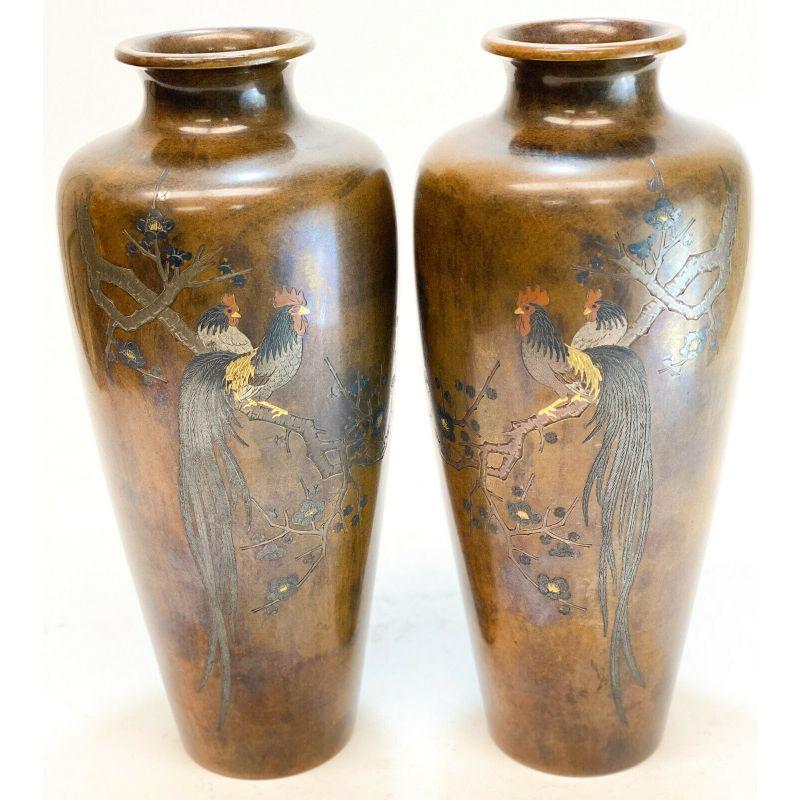 Pair of Japanese Meiji Period bronze mixed metal inlay rooster vases.

Bronze base with silver, gold, and copper inlay.

Additional Information:
Region of origin: Japan 
Primary material: bronze
Featured refinements: Meiji Vase
Dimension: