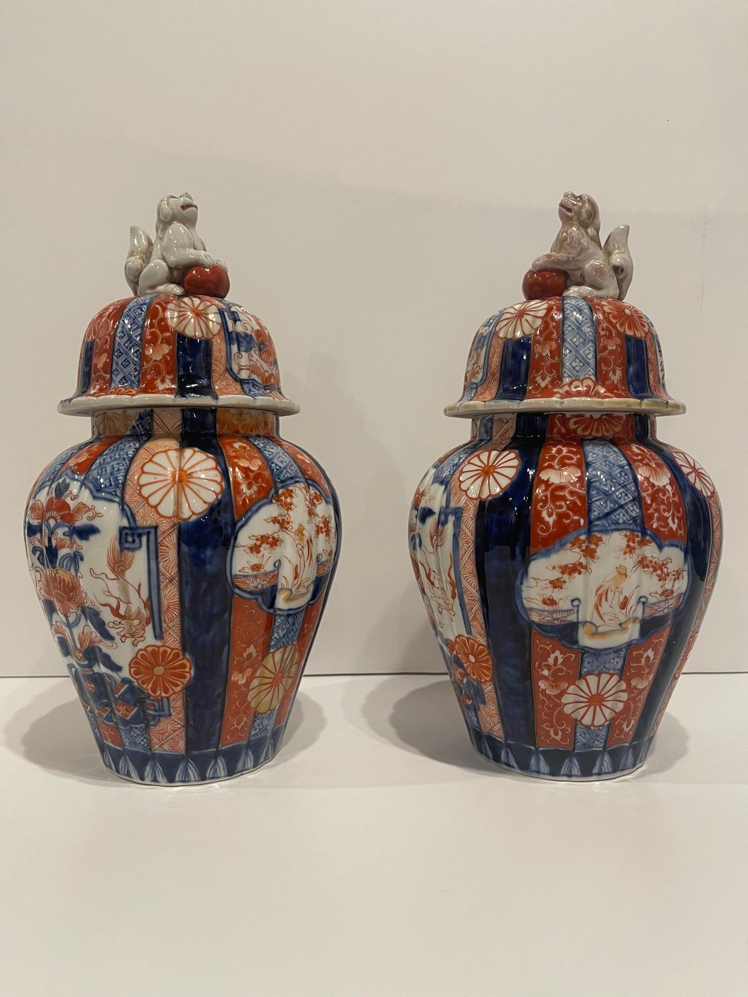 Pair of Japanese Meiji Period Porcelain Lidded Jars, 19th Century .  Wood stands are included
