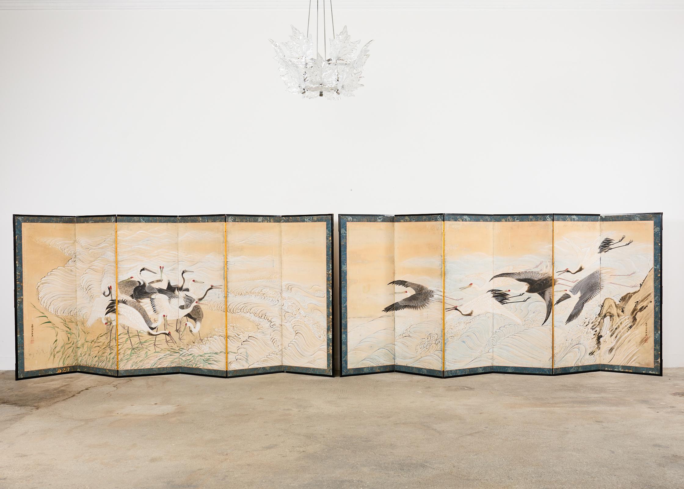 Amazing 19th century pair of large Japanese Meiji period six panel screens each depicting a sedge of Manchurian red-crowned cranes along the shore. The screens are crafted in the Nihonga school style with intricate details and beautifully depicted