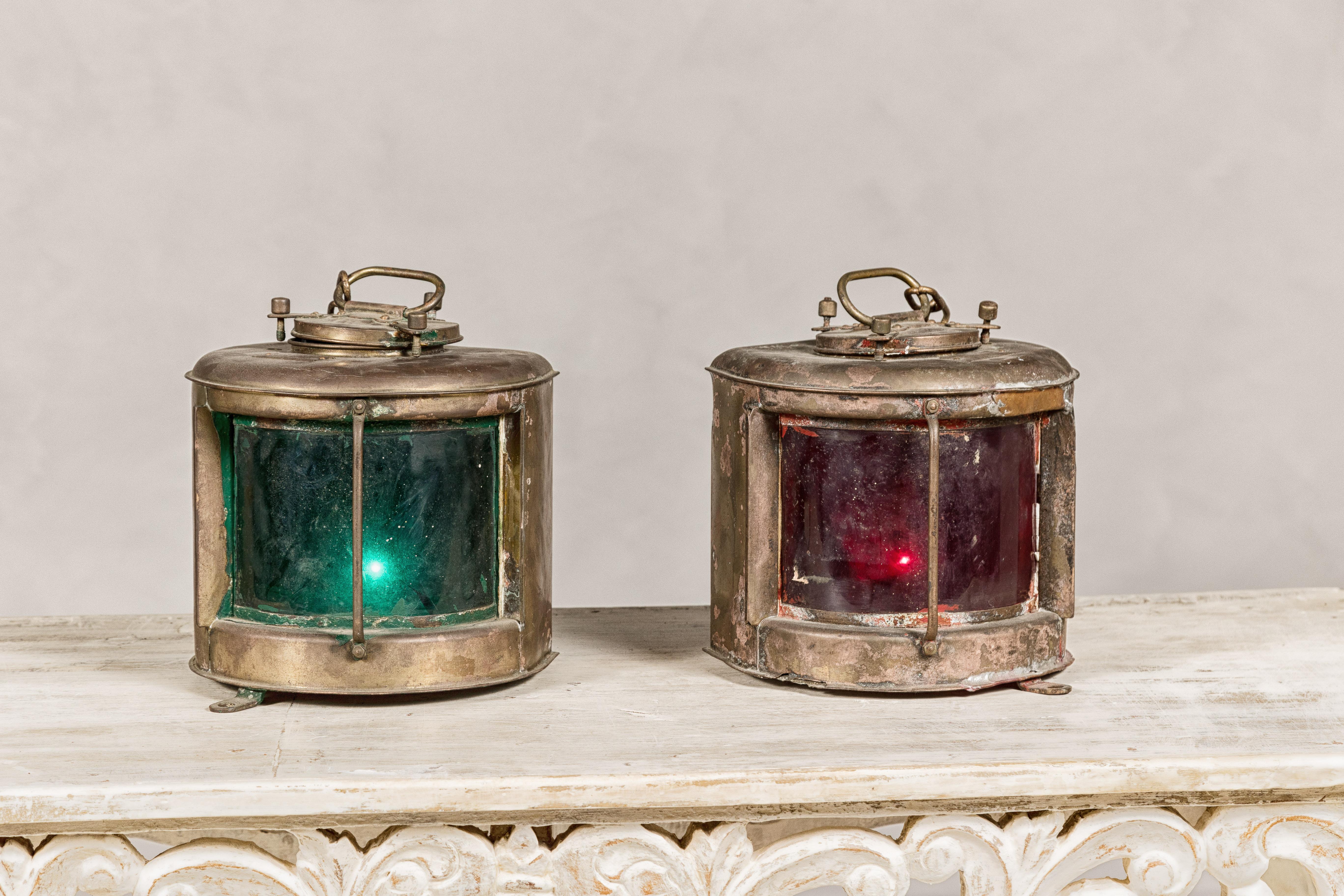 A pair of Japanese Nippon Sento ship lanterns circa 1966 with green and red glass. These authentic Japanese Nippon Sento ship lanterns, dating back to 1966, are a maritime enthusiast's treasure. Constructed with robust metal casings, they house