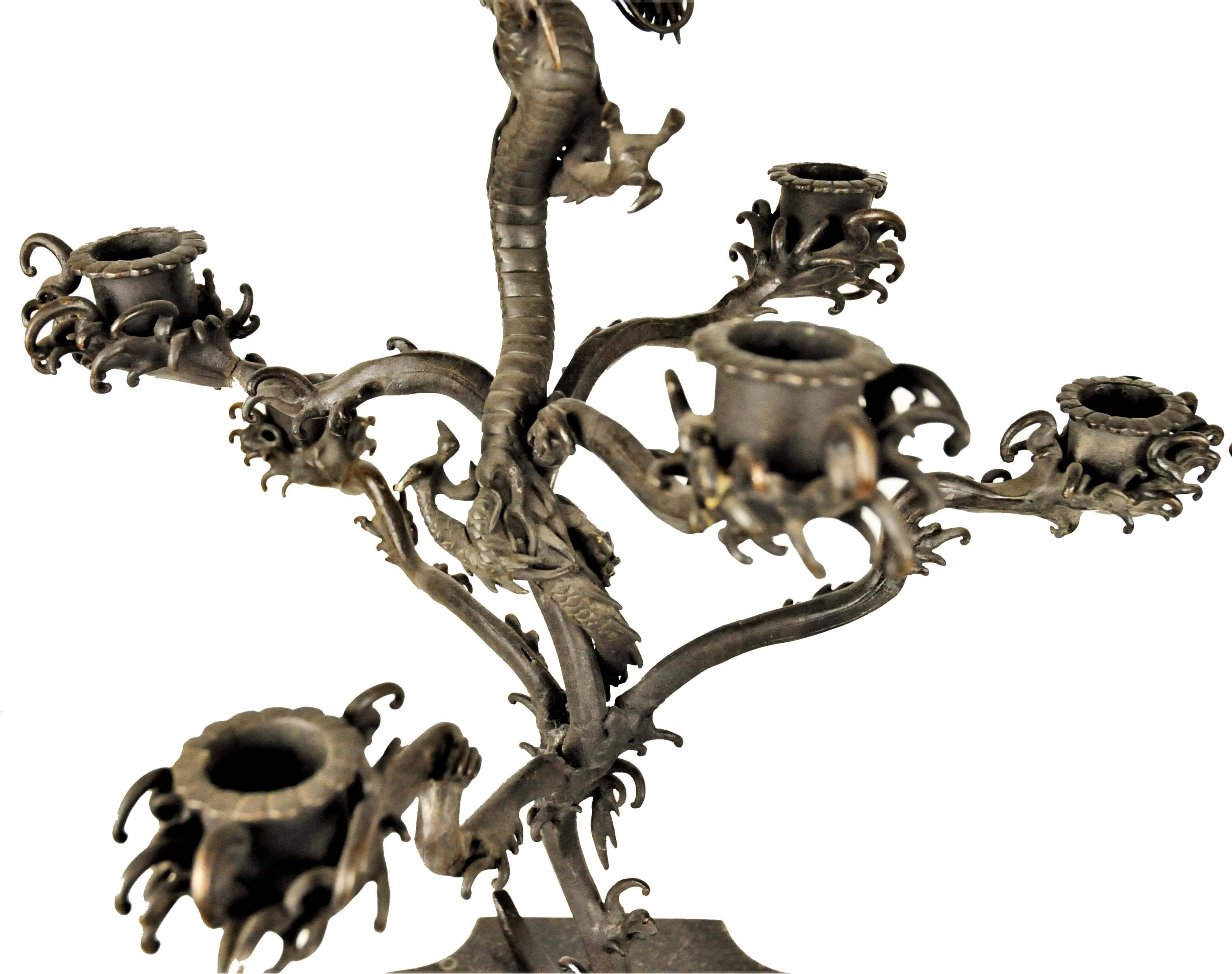 This most unusual pair of original 18th century Japanese patinated bronze candelabras, uniquely designed as branches of mountain flowers entangled by a dragon, are mounted on the contemporary marble bases.
