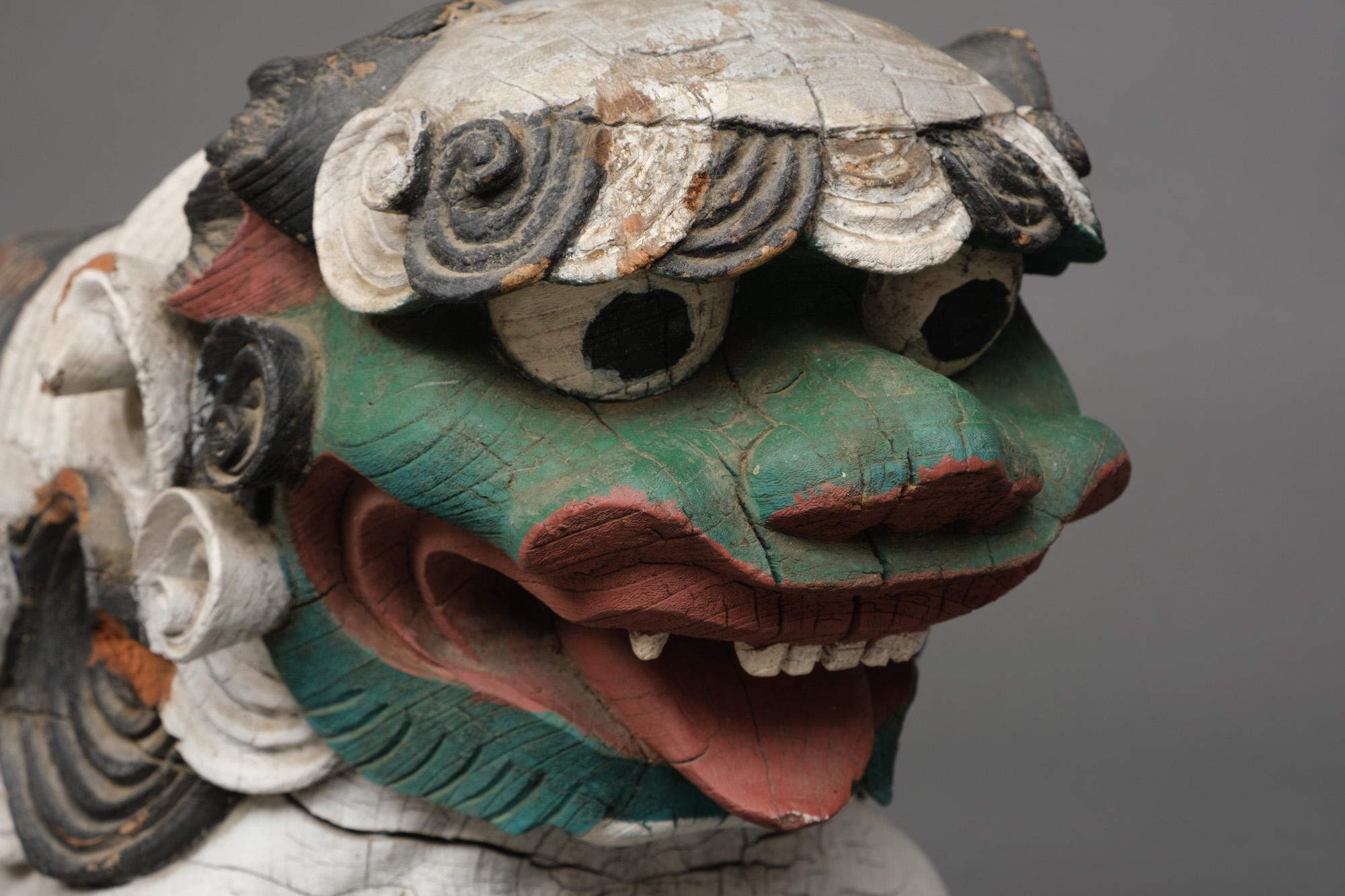A striking pair of finely carved wooden temple ornaments (kibana) in the shape of threatening shishi (temple lions) painted in the colours green, red, black and white. These are rarely seen completely painted polychrome.

They were ornaments